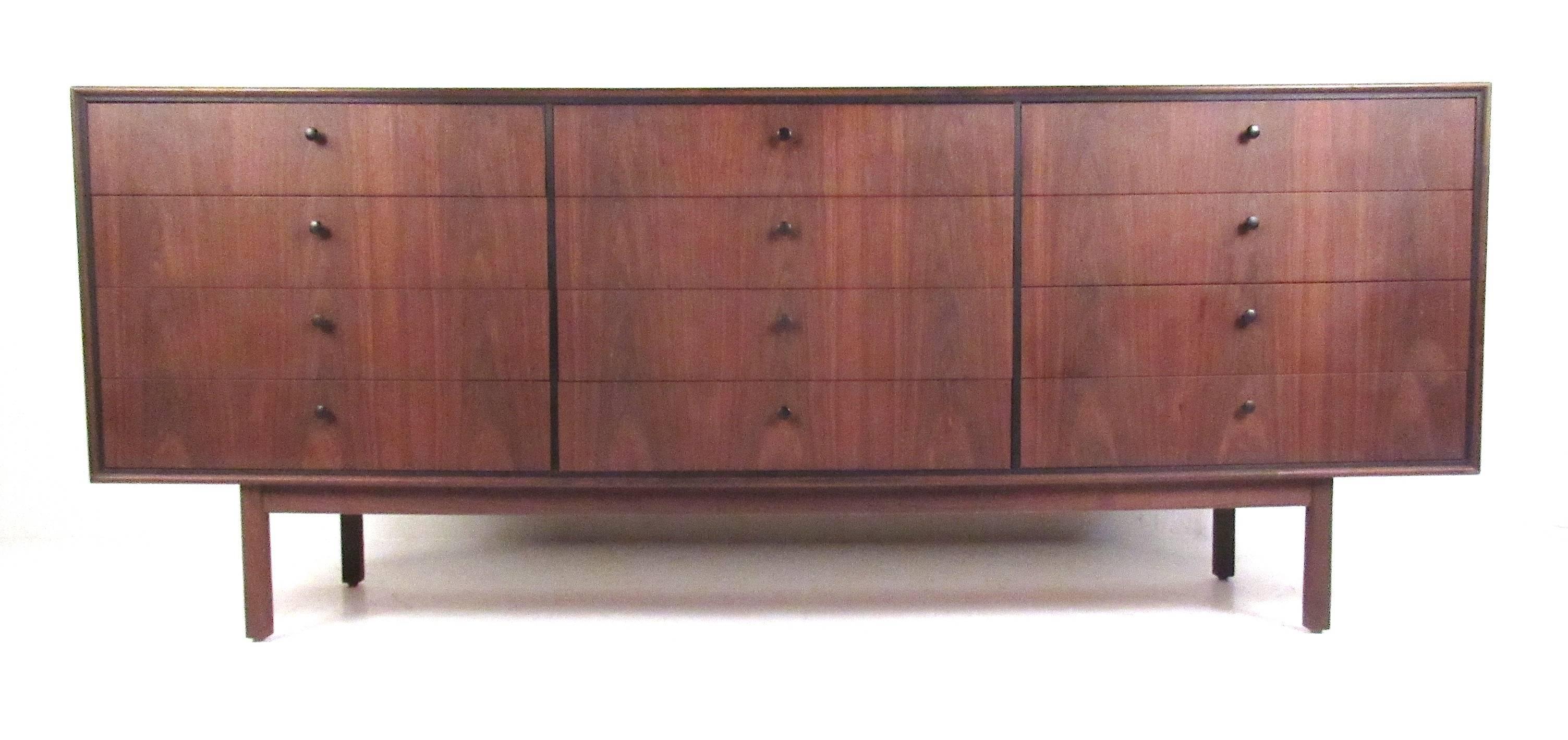 Beautiful, matching grain, 12-drawer walnut dresser with black pulls and detail trim. An elegant Mid-Century storage solution. Please confirm item location (NY or NJ) with dealer.
 