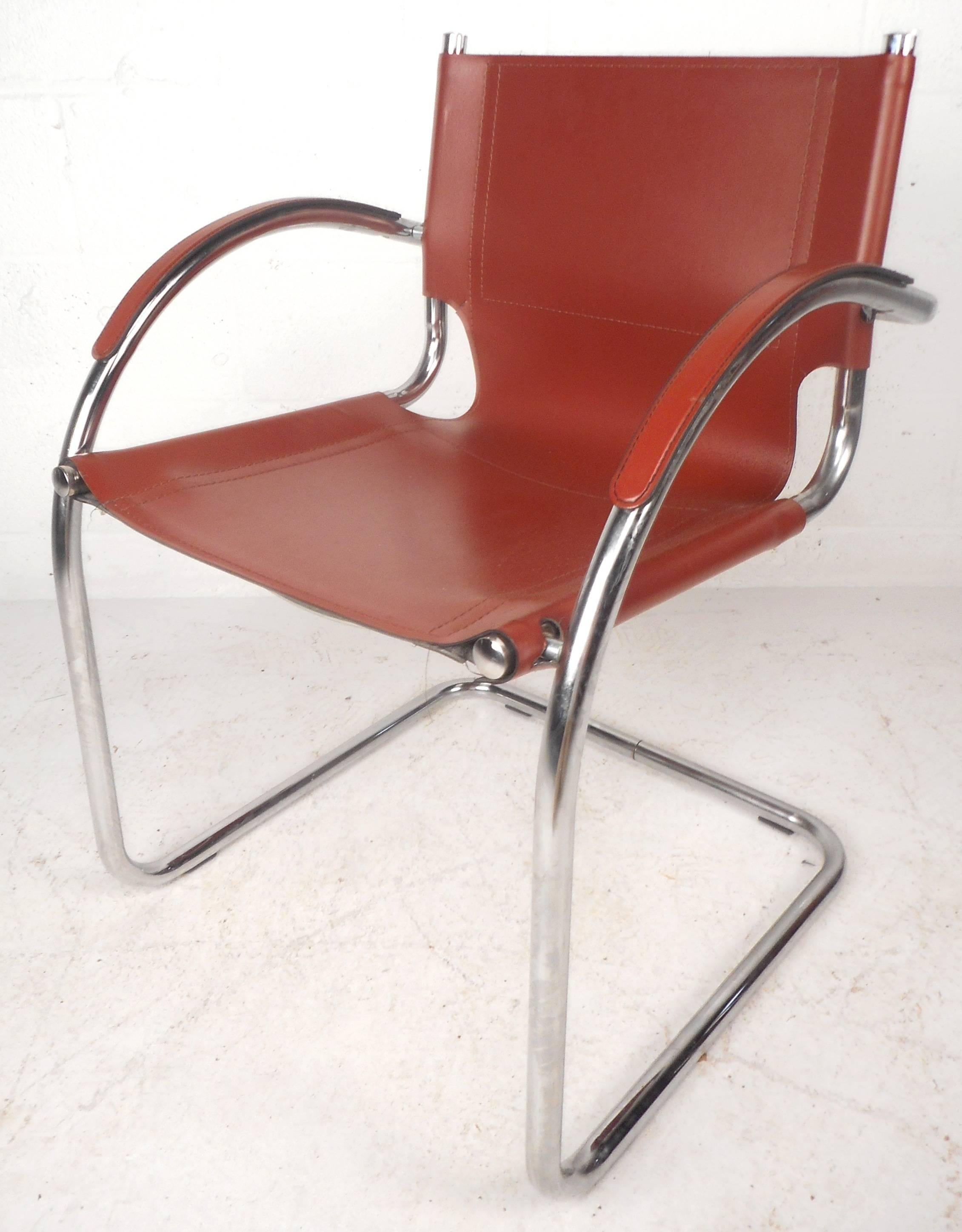 This stunning vintage modern set of four cantilever dining chairs feature sleek red leather seating and back rests. The rounded arm rests have stitched leather ensuring optimal comfort and style. Heavy tubular chrome cantilever frame provides