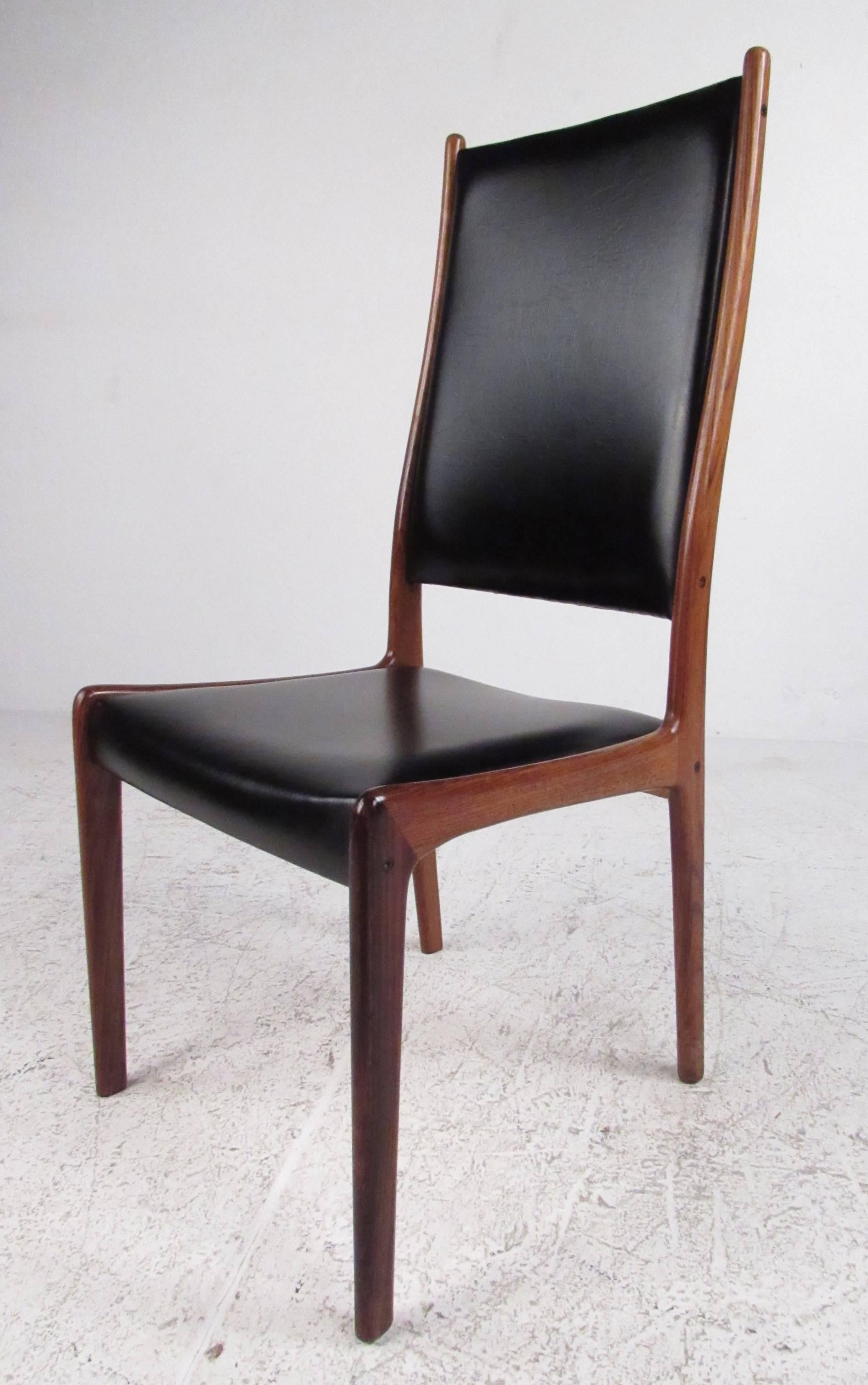 Set of six rosewood with black faux leather upholstery dining chairs by noted furniture designer Johannes Andersen. Beautifully detailed solid wood frames with dovetail joints and Danish Makers Control mark on each. Please confirm item location (NY