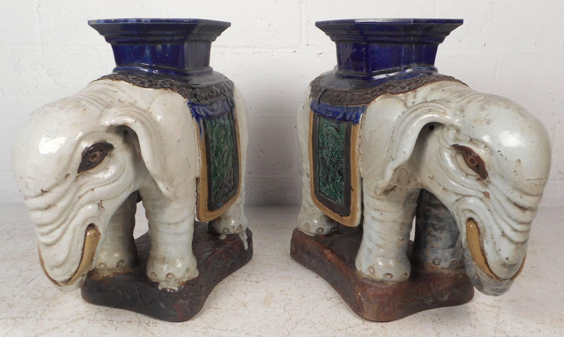 This beautiful Mid-Century Modern pair of elephant tables feature incredible detail throughout with various elaborate colors and designs. These functional and unique pieces of art can serve as plant stands, end tables, or simply decorative.