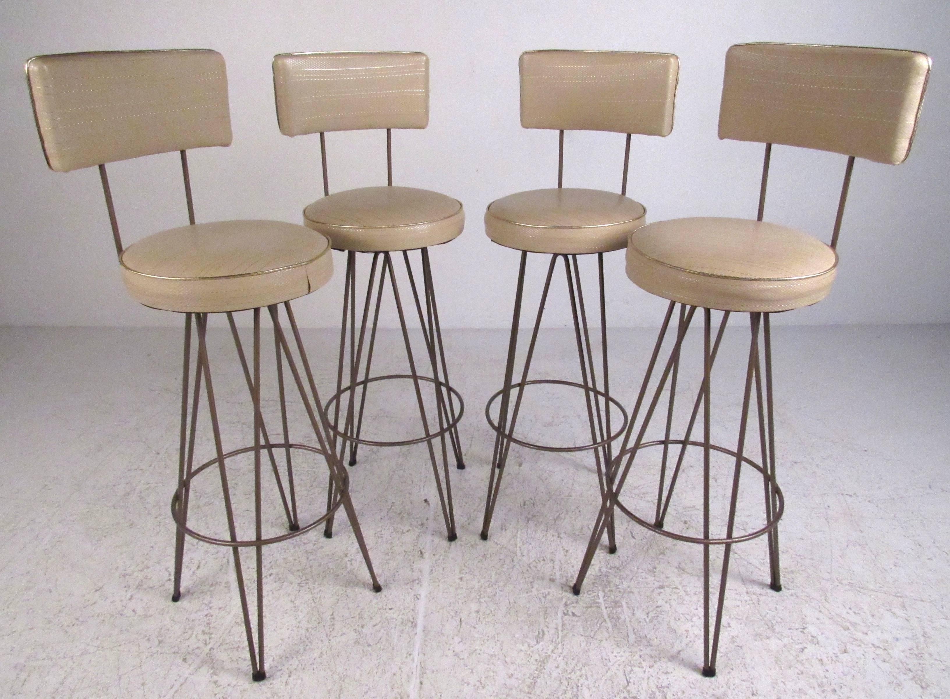 Great set of four Mid-Century swivel bar stools with period vinyl upholstery and sturdy bronze color metal bases. Please confirm item location (NY or NJ) with dealer.