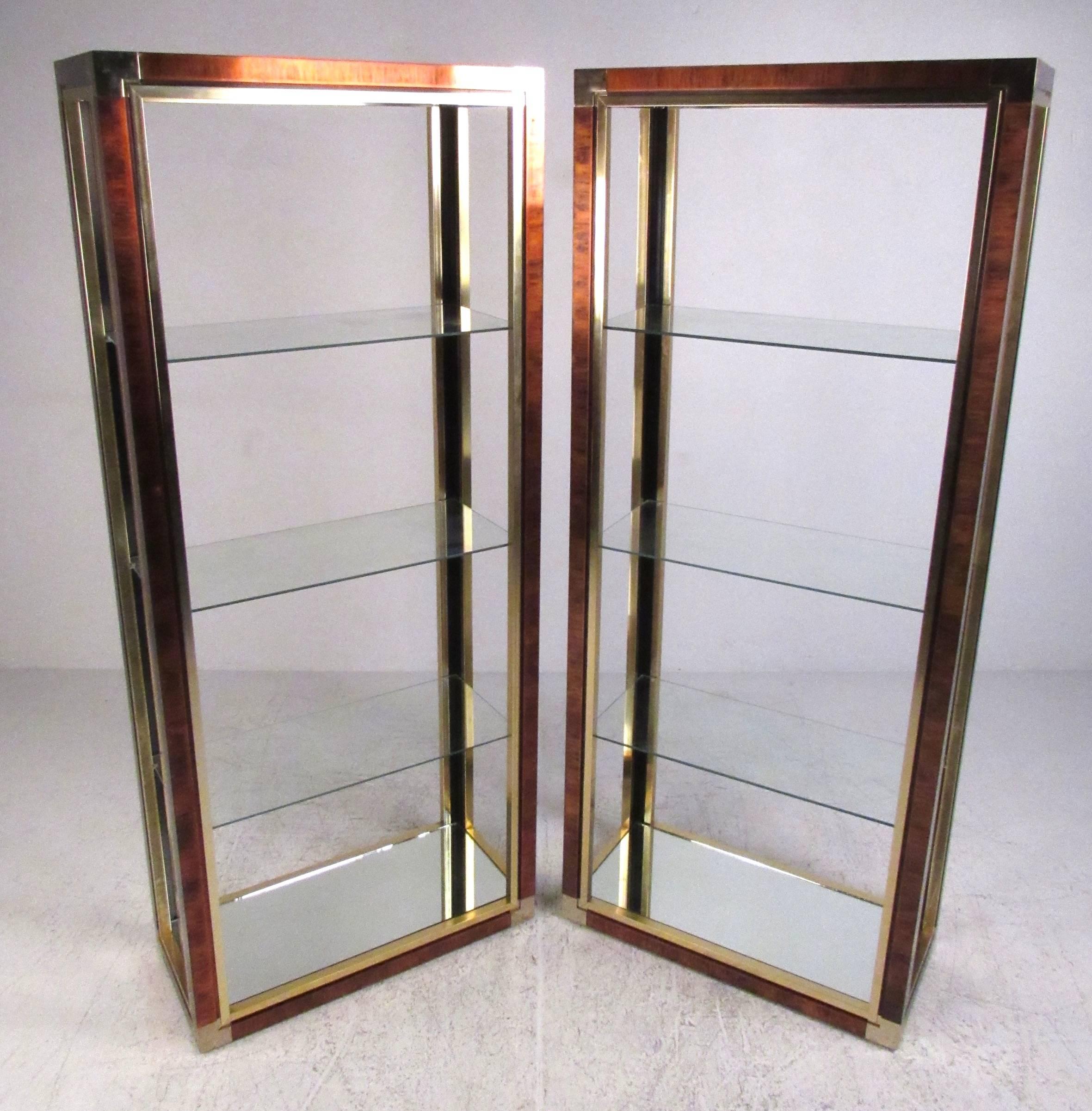 Matching pair of modern four shelf etageres with contrasting brass and lacquered metal finish. Mirrored base shelf with three clear stationary shelves. Please confirm item location (NY or NJ) with dealer.