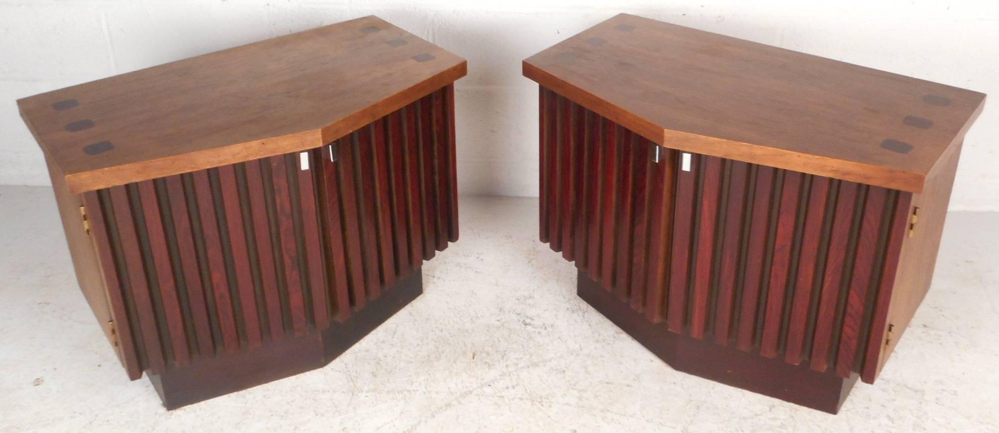 This beautiful pair of vintage modern nightstands are made of walnut with unique rosewood fronts. Unique shapely design with chrome pulls on each cabinet door. Stylish pair of end tables with plenty of space to store items and a large top to place