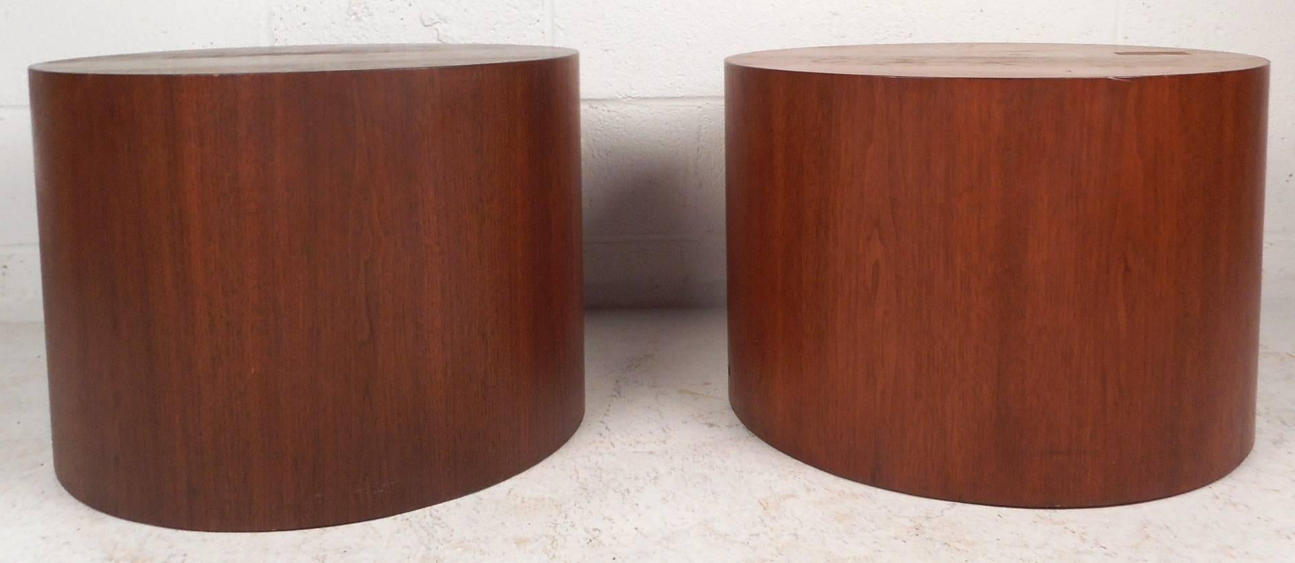 This stunning pair of vintage modern end tables feature a unique cylindrical shape. This simple and functional design can also be used as a pedestal showing true quality craftsmanship. Unusual style and gorgeous walnut wood grain makes this