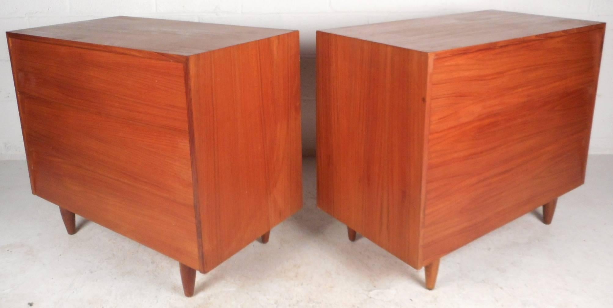 This beautiful vintage modern pair of gentleman's chests feature three hefty drawers with dove tail joints for storage. Elegant teak finish and stylish tapered legs add to the allure. Quality craftsmanship with a straight line design make this