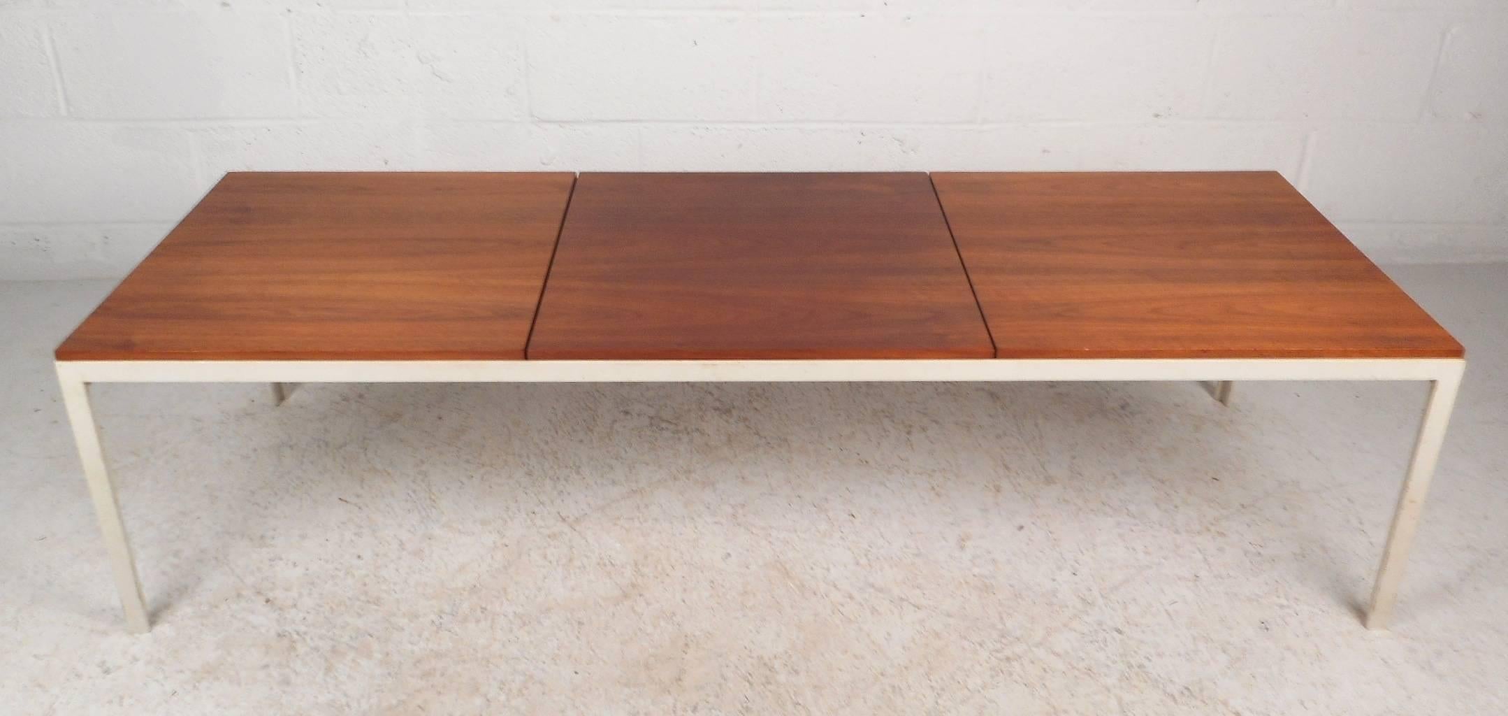 This gorgeous vintage modern coffee table features a heavy metal painted frame with a walnut wood top. Unique design displays three separate pieces on the tabletop. Rich walnut wood grain and a sleek straight design add to the Mid-Century appeal.