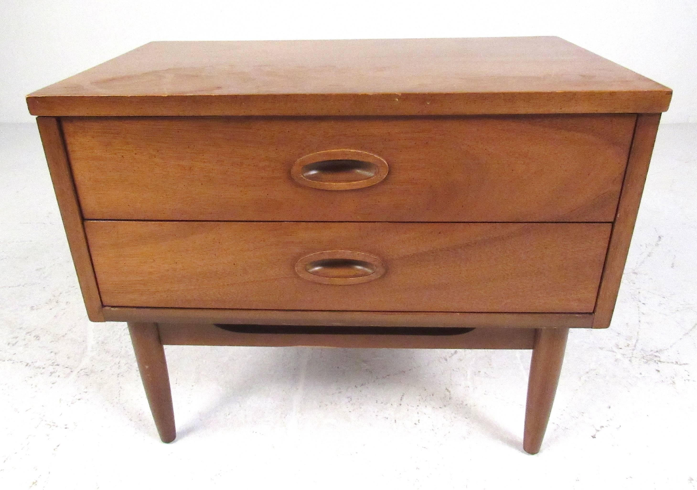 Two-drawer walnut nightstand by Dixie Furniture Co. Please confirm item location (NY or NJ) with dealer.