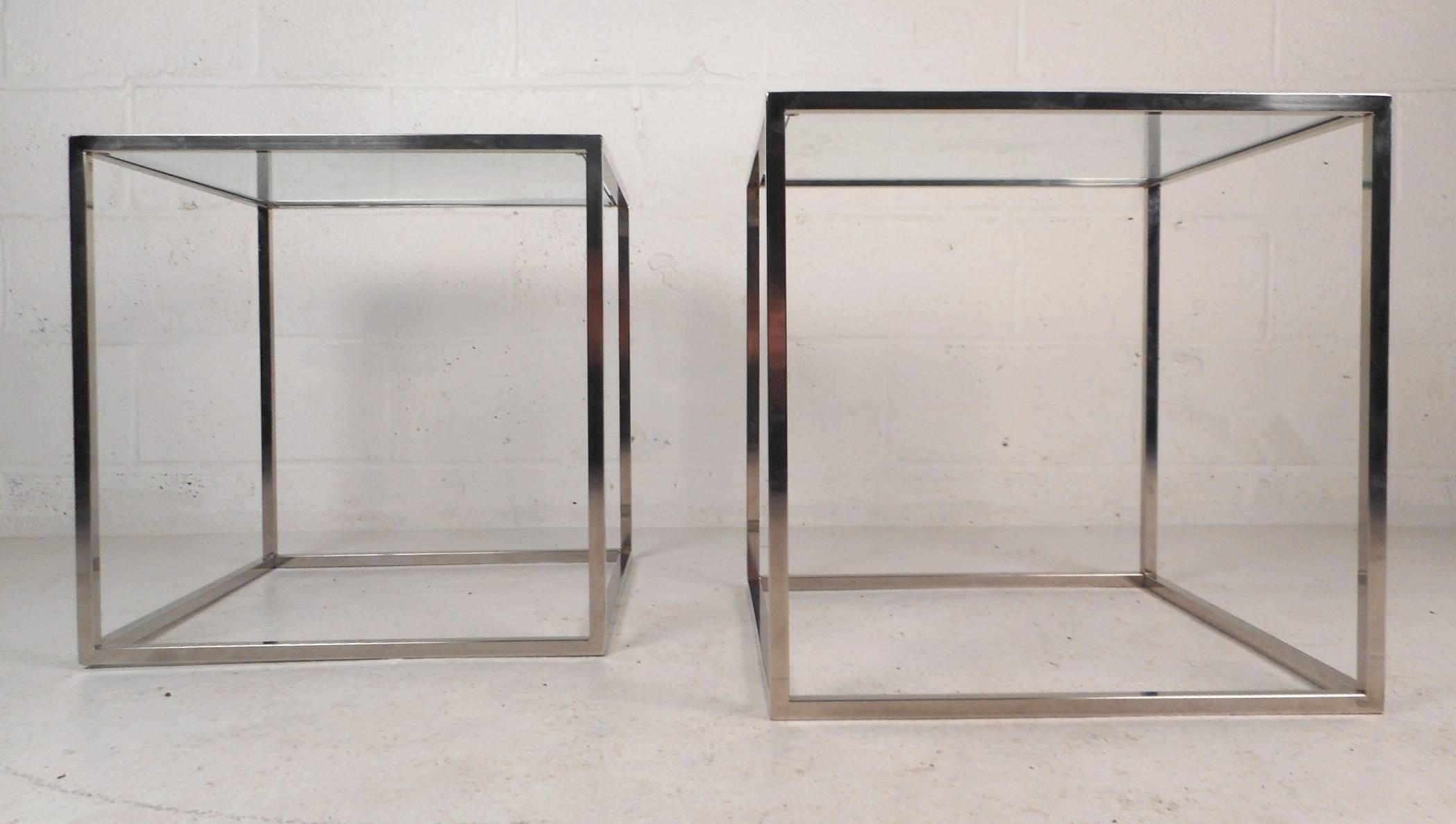 Beautiful pair of vintage modern end tables with a chrome frame and a glass top. This elegant piece forms the perfect cube showing quality design. This sleek Mid-Century pair is sure to add style and grace to any modern interior. Please confirm item