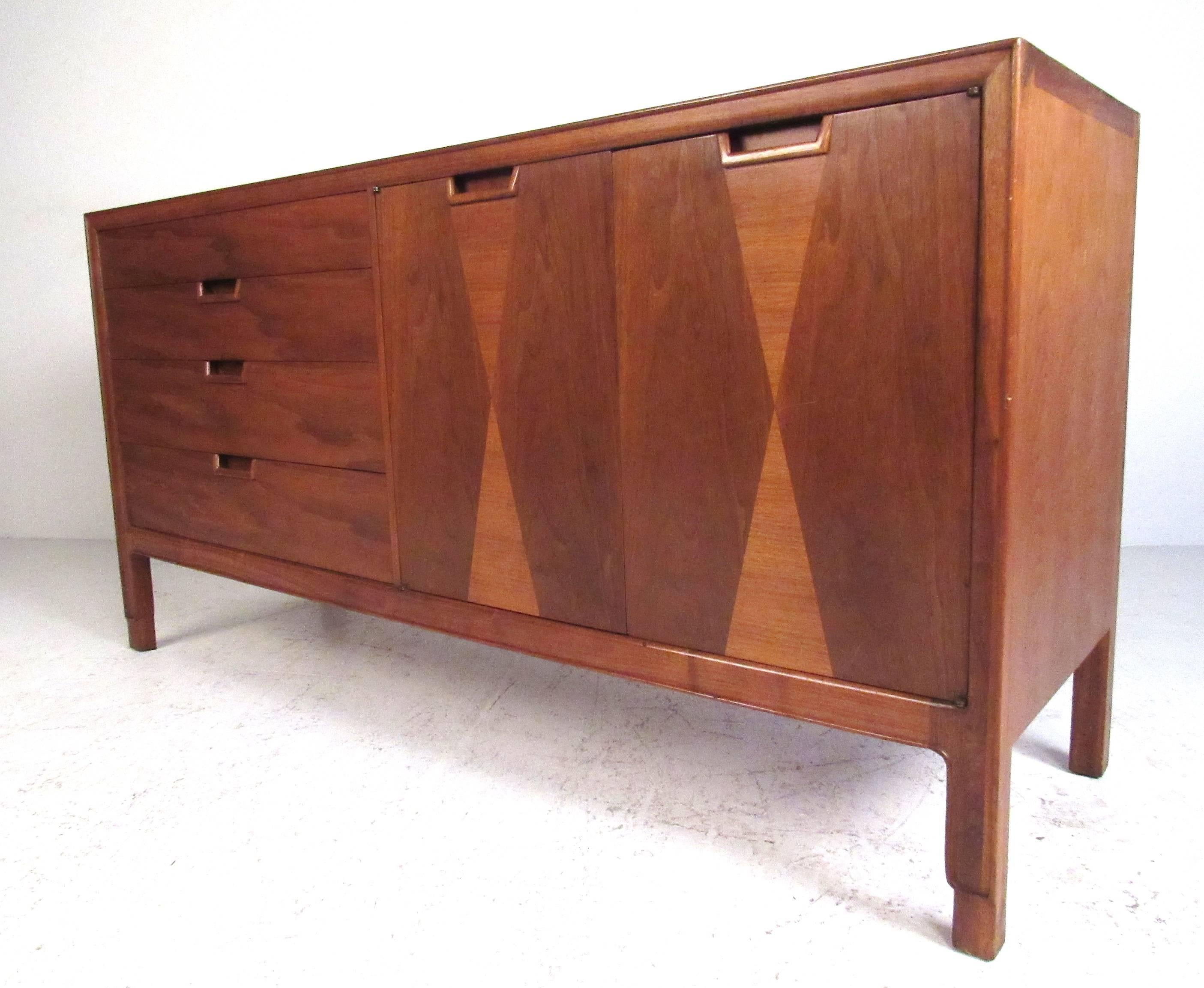Nicely designed smaller scale sideboard by John Stuart as part of the Janus collection for Mt Airy Furniture. Featuring walnut construction with patterned inlay, dovetail joints, recessed pulls, and makers stamp on inside drawer. Please confirm item