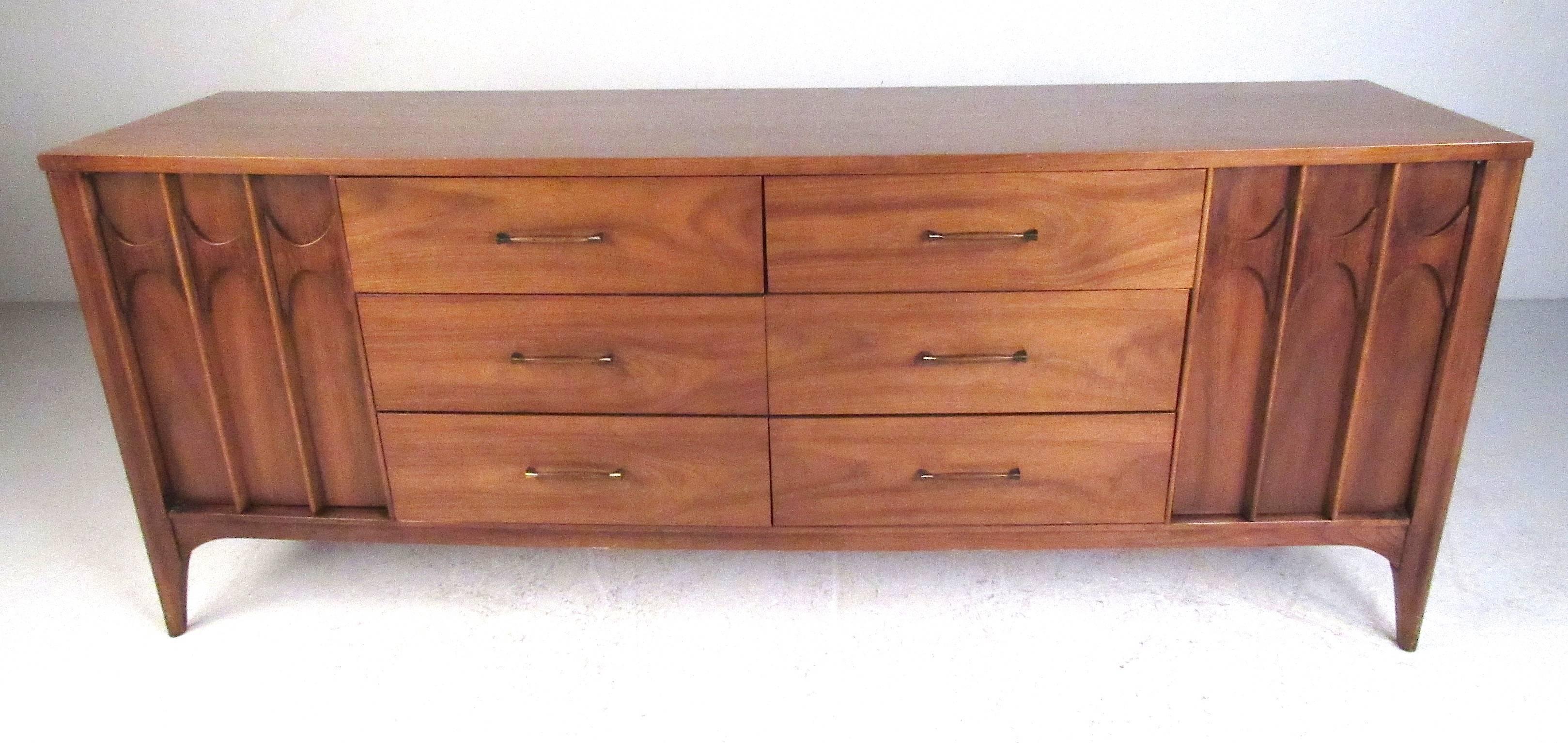 Mid-Century walnut dresser with six center drawers flanked by two doors with three drawers each. Well made and nicely detailed this dresser was designed and manufactured by Kent-Coffey, North Carolina, in the 1960s. Please confirm item location (NY