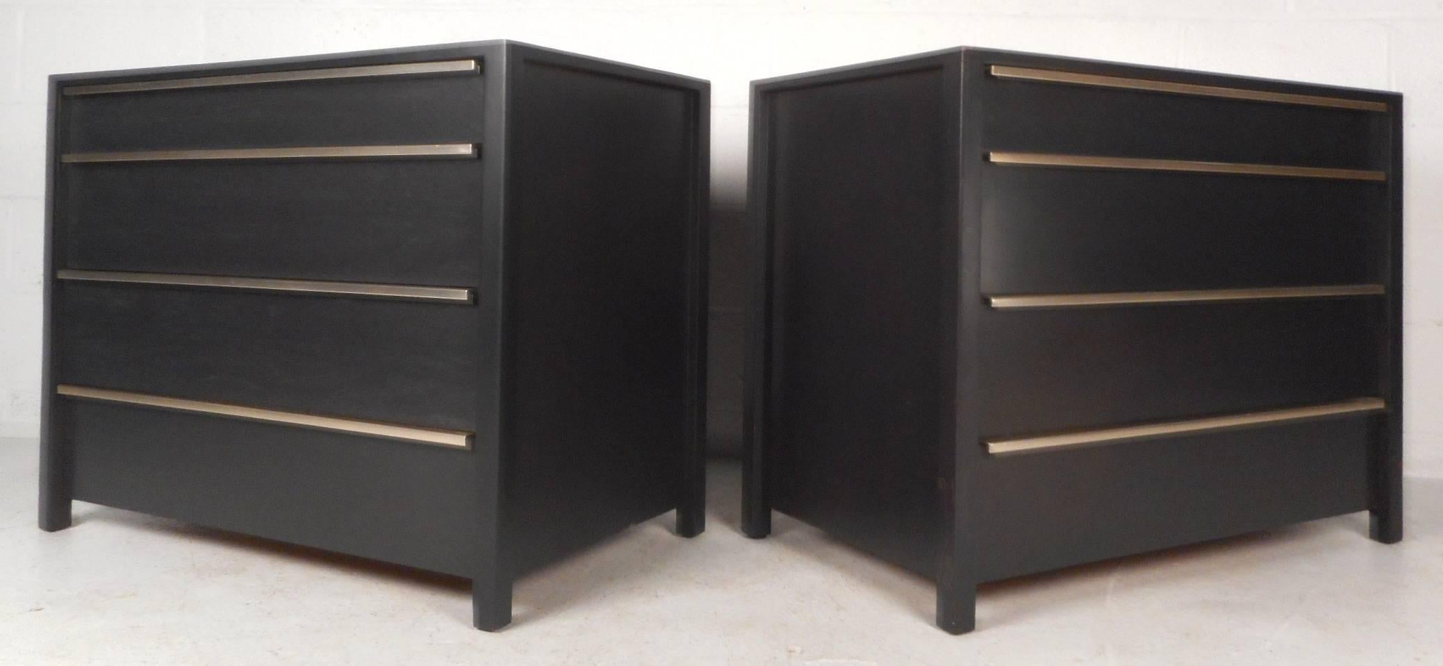 This gorgeous pair of vintage modern dressers feature unique metal pulls that stretch across the top of each drawer. Sleek design with an elegant ebonized finish and raised edges along each side. This stunning pair has eight hefty drawers ensuring