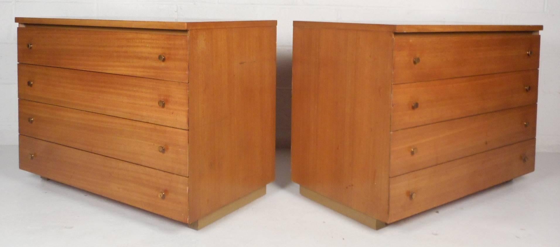 Beautiful vintage modern pair of dressers feature plenty of room for storage within its eight hefty drawers combined. Elegant maple wood grain, unique brass pulls and a finished back show quality craftsmanship. Sleek and sturdy design with unusual