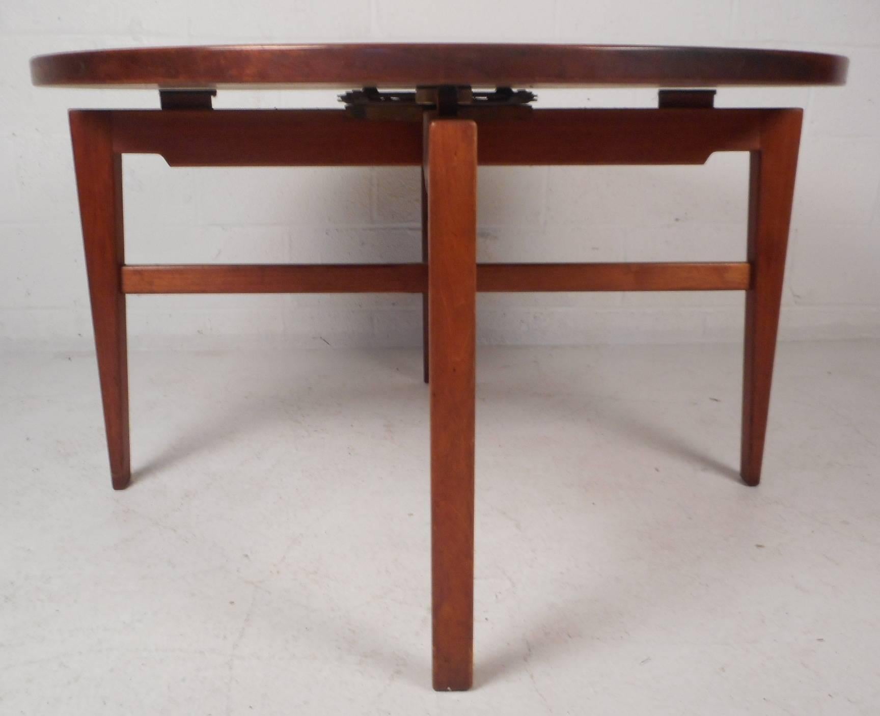 This beautiful vintage modern set features a "Lazy Susan" cocktail table that revolves and has a brake mechanism to hold it firmly in place. Stylish game table with long tapered legs and stretchers that intersect underneath to form an