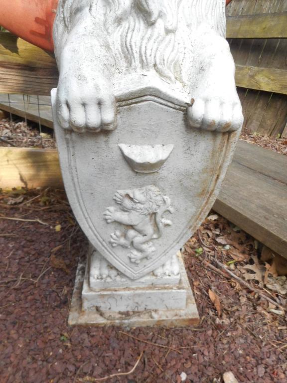 Pair of Cast Iron Lion Statues Holding a Shield For Sale at 1stDibs