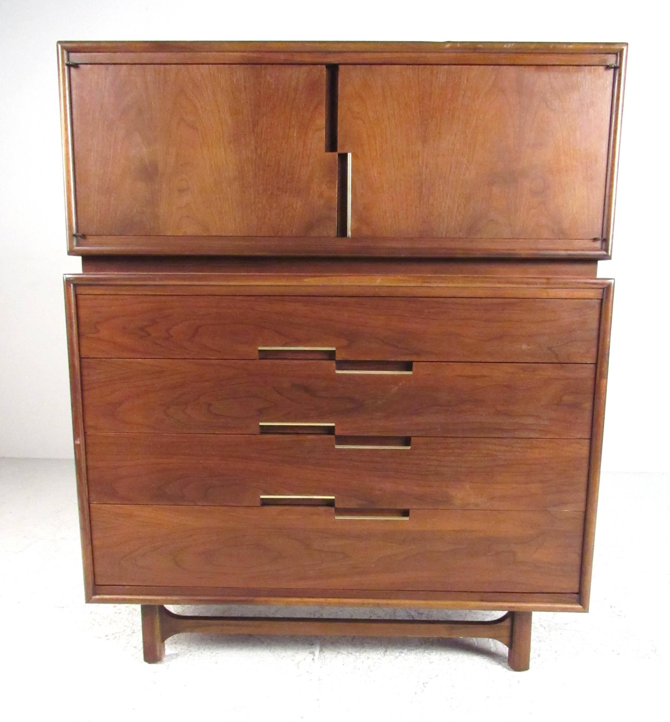 High quality mid-century walnut dresser produced by Cavalier. Two door cabinet on top containing two notch top drawers and shelf storage. Four drawers below with two partitioned and one cedar lined. Recessed pulls with metal trim. Please confirm
