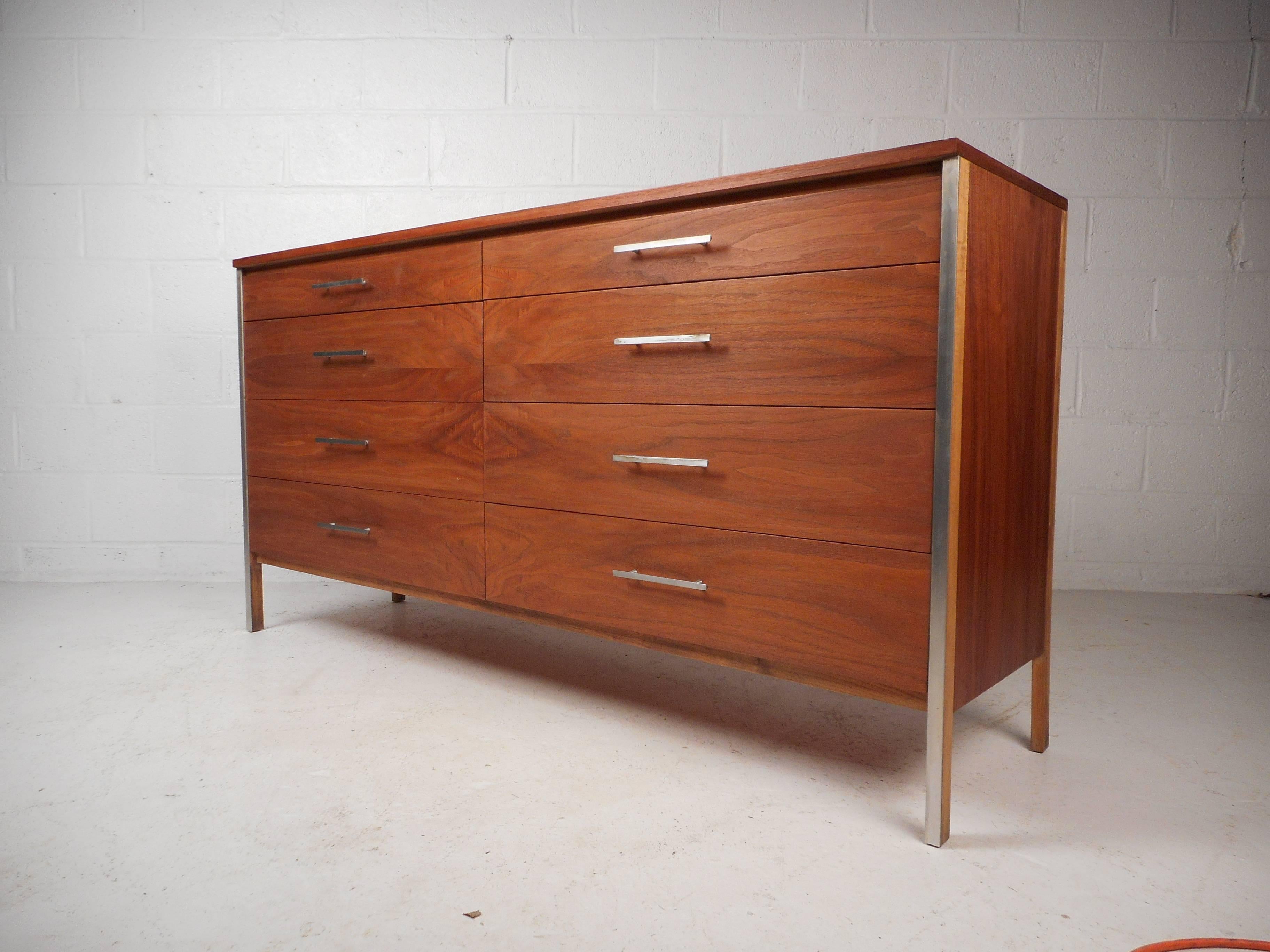 Beautiful Paul McCobb walnut dresser with aluminum drawer pulls and leg accents. Striking mid-century modern dresser designed for Calvin furniture makes the perfect vintage addition to any bedroom. Please confirm item location (NY or NJ) with dealer.