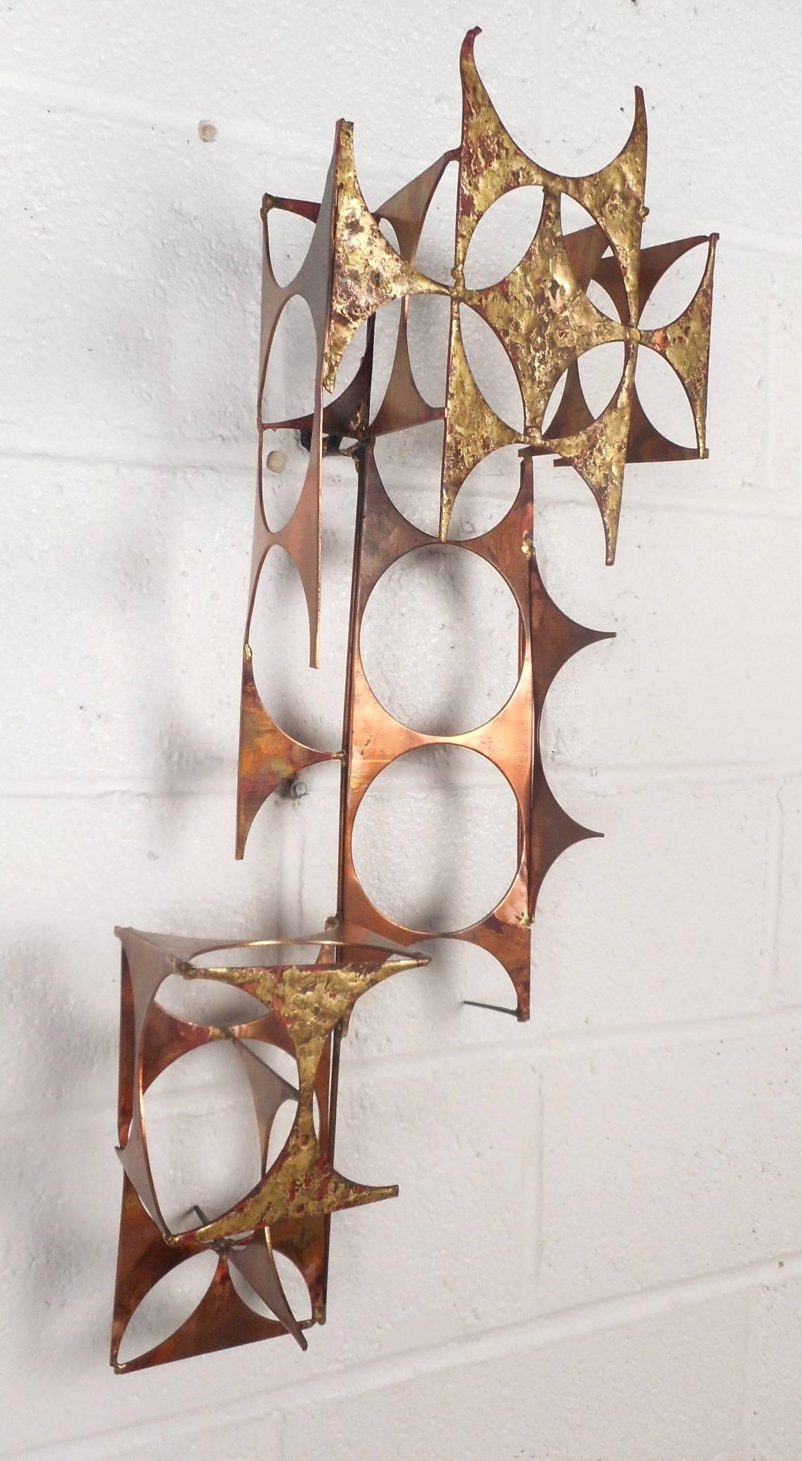This beautiful vintage modern wall sculpture is made of mixed metals and features unique three dimensional designs. Versatile piece of art can be hung vertical or horizontal. Elegant mid-century decoration shows incredible detail and elaborate