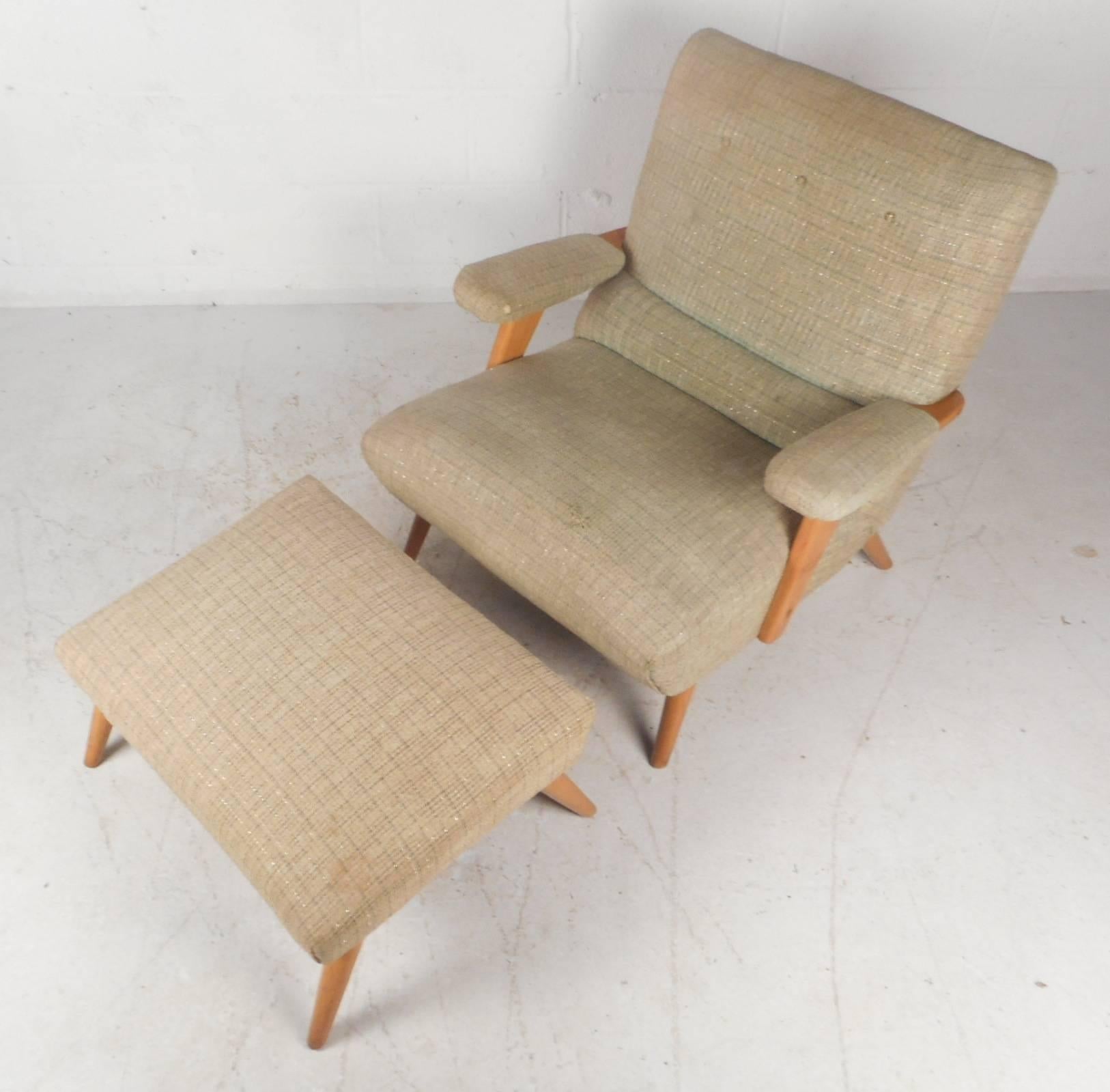 This gorgeous pair of vintage modern lounge chairs offers plenty of comfort with their thick padded seating and arm rests. Sleek design with angled and tapered legs made of solid maple wood. Unique and stylish lounge chairs with wide upholstered arm