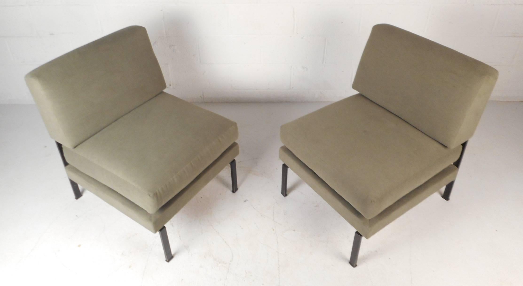 This elegant vintage modern pair of lounge chairs feature the ability to adjust in depth from 23 inches to 30 inches providing a variety of seating positions. Sleek design with lovely plush green upholstery and a heavy iron frame. Unique Italian