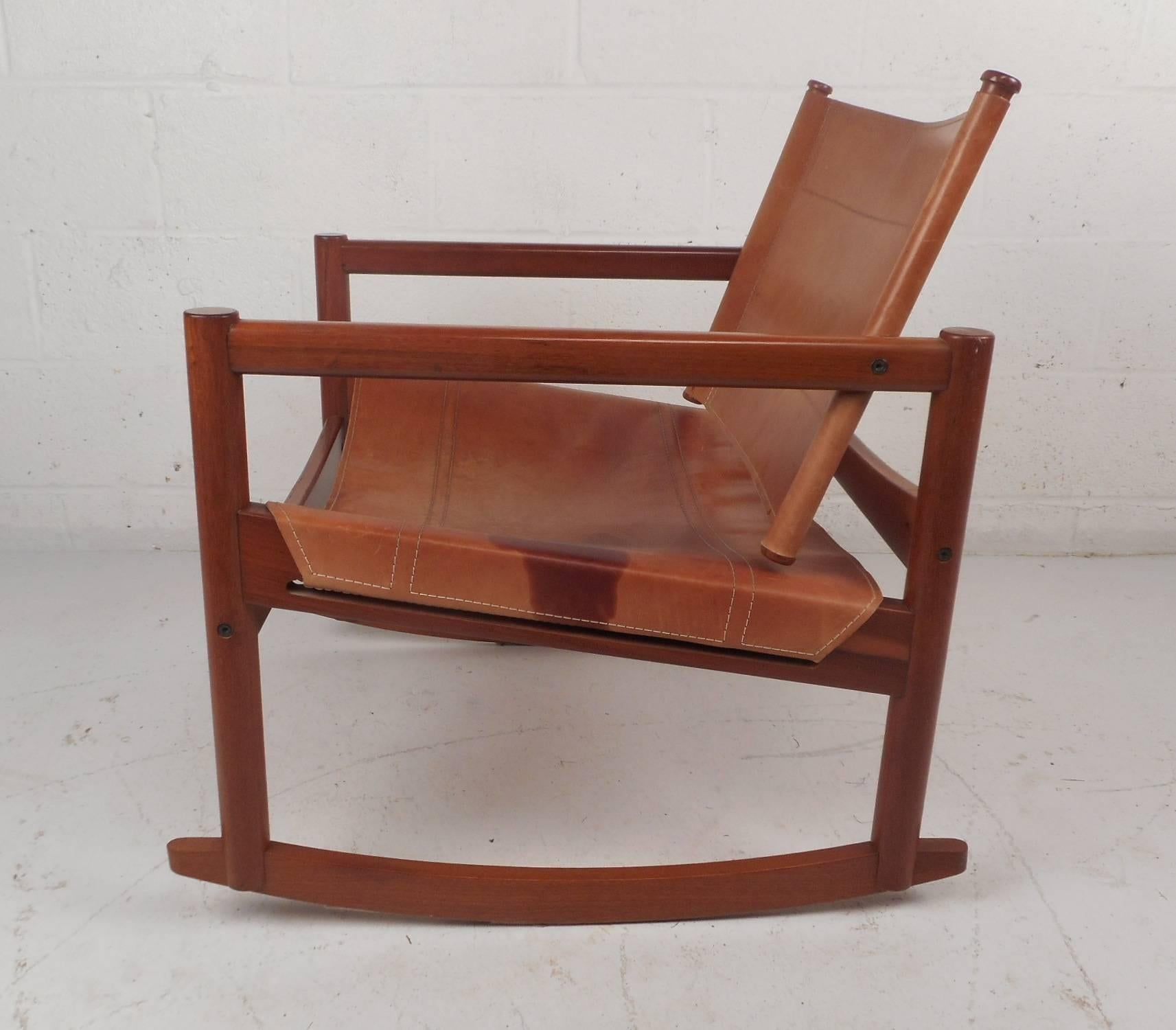 This gorgeous vintage modern rocking chair features leather seating and a wood frame. Unique Brazilian design ensures maximum comfort without sacrificing style. Stunning wood grain and a sculpted frame add to the Mid-Century appeal making this the