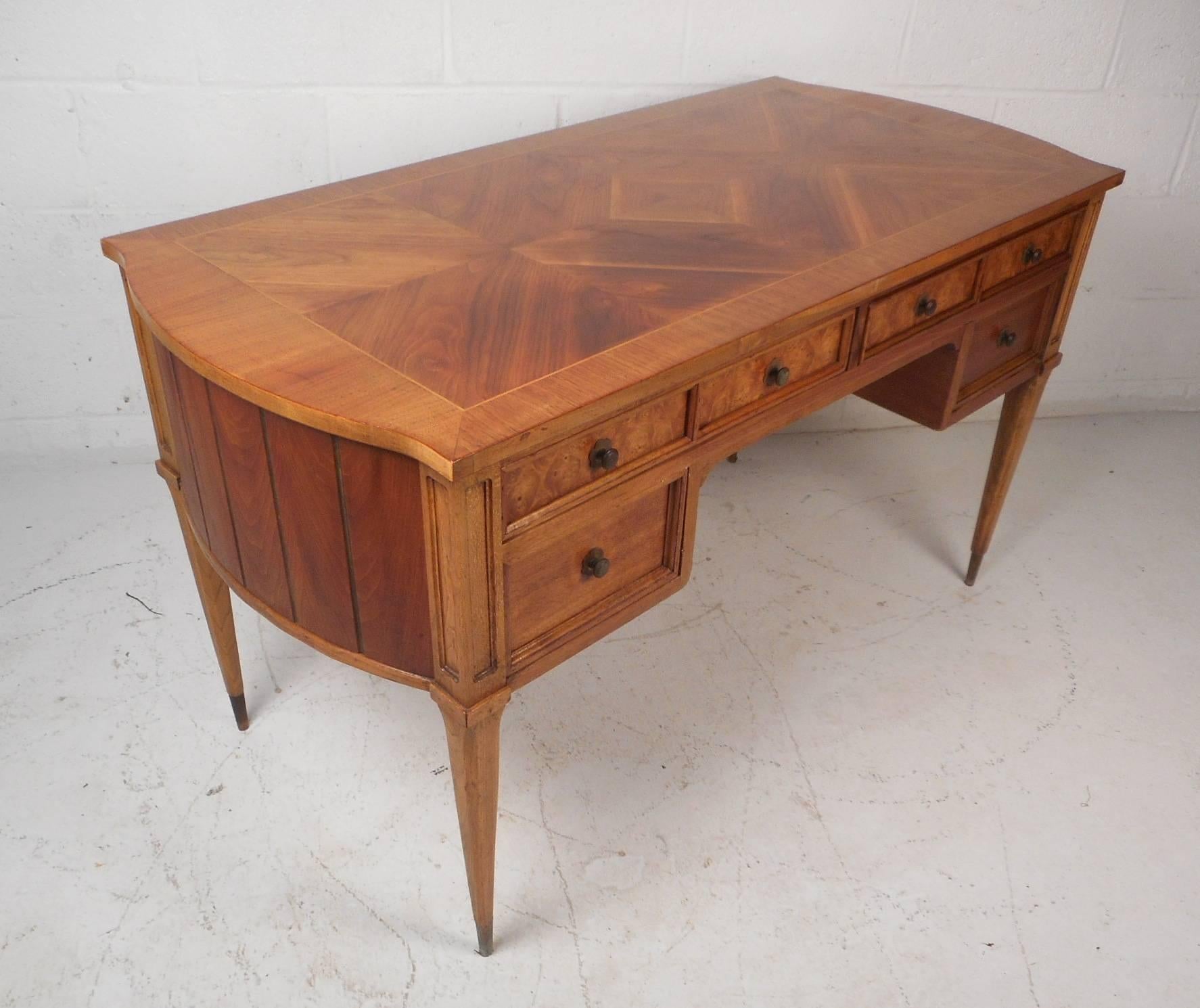 This stunning vintage modern desk features a unique two-tone design with multiple wood types. One of a kind case piece with amazing wood grain on the top running in different directions and a finished back. Intricately designed desk with bowed