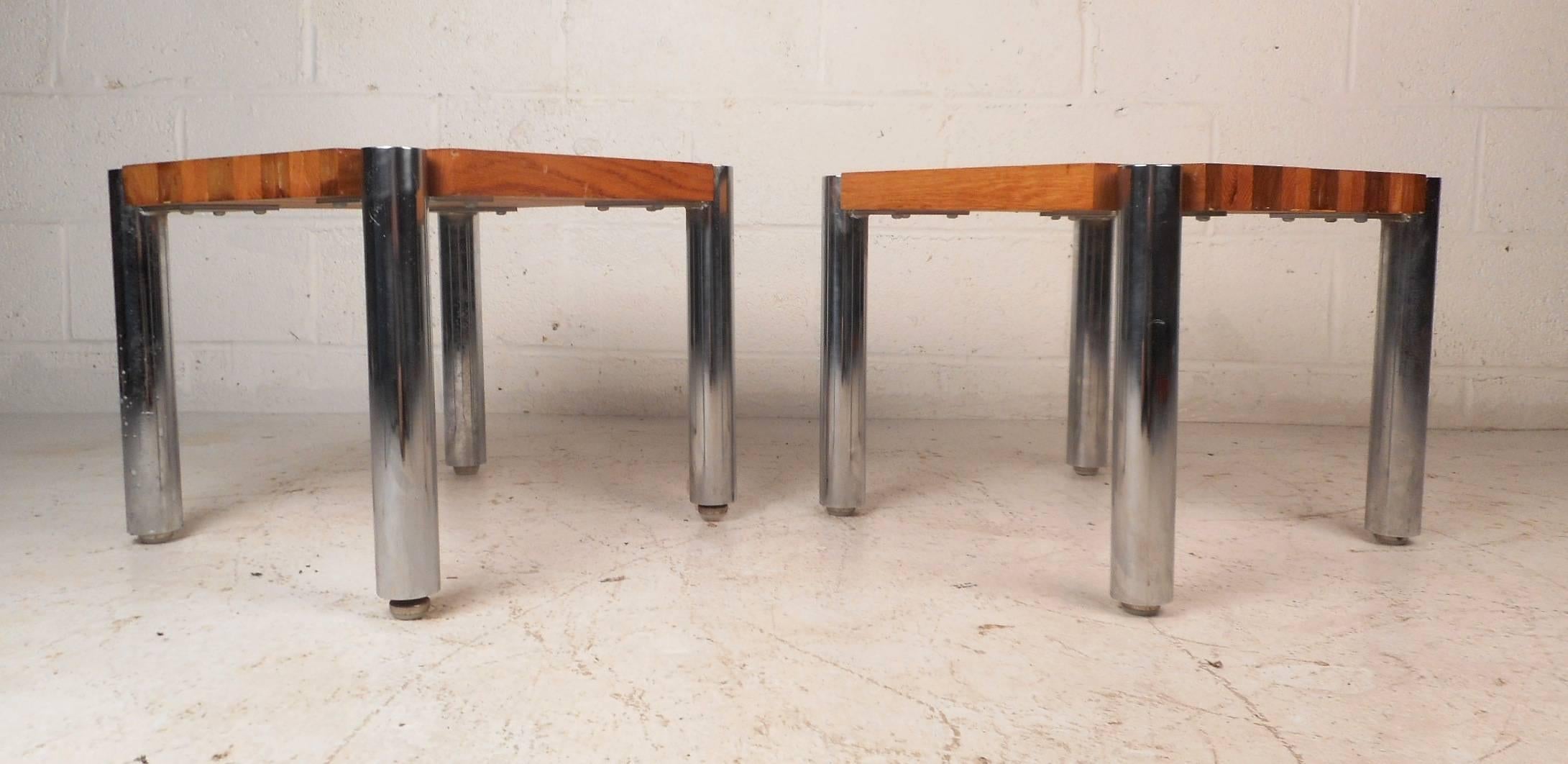 This gorgeous pair of vintage modern end tables feature a wonderful two-tone design with lovely teak wood grain. These unique pieces have large cylindrical chrome legs ensuring sturdiness and style. These stunning midcentury end tables make the