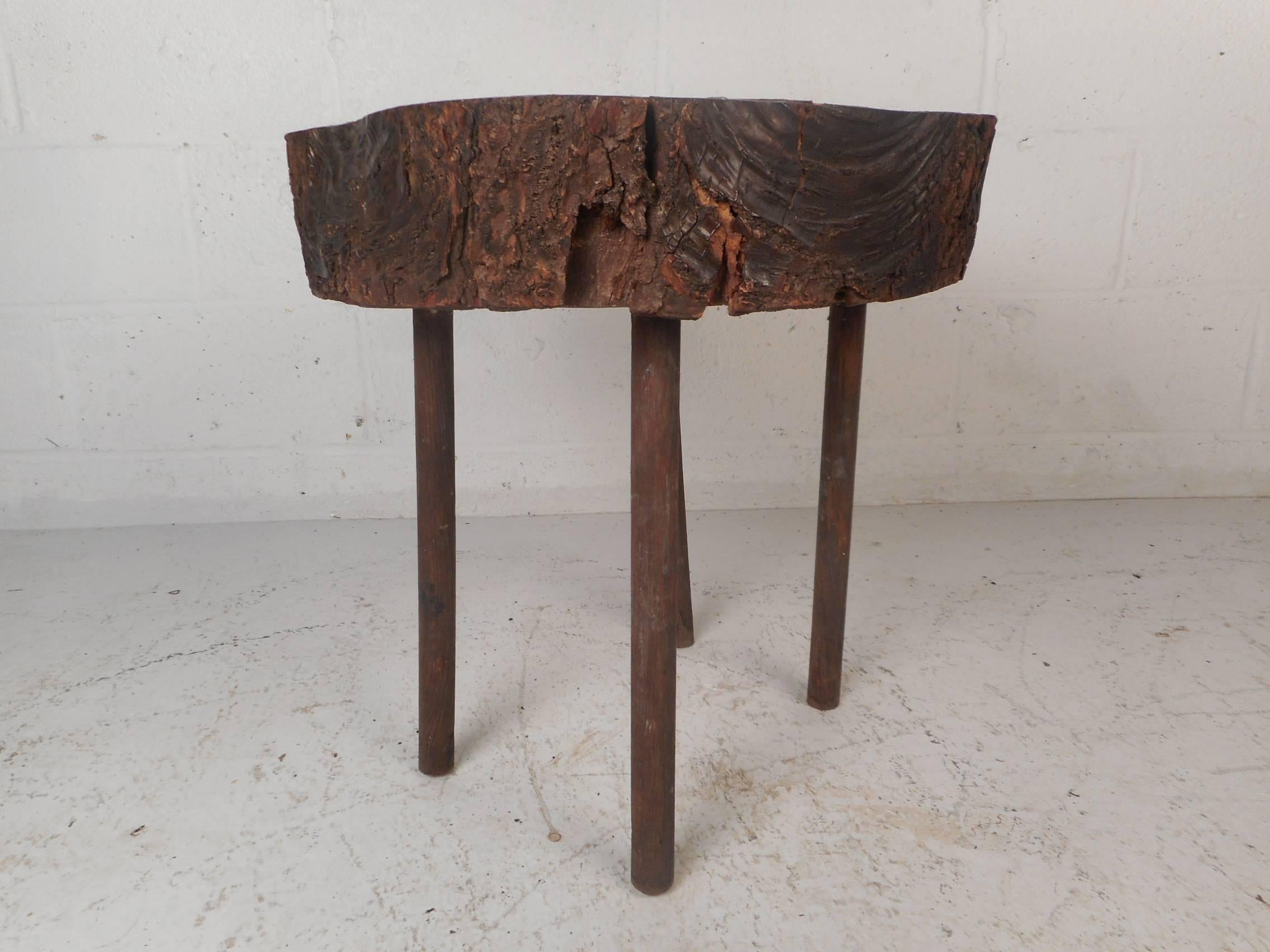 This beautiful vintage modern end table features a live edge tree slab top. Stylish design with four cylindrical wood legs and a lacquered free-form wood top. Quality craftsmanship makes this mid-century side table the perfect addition to any modern