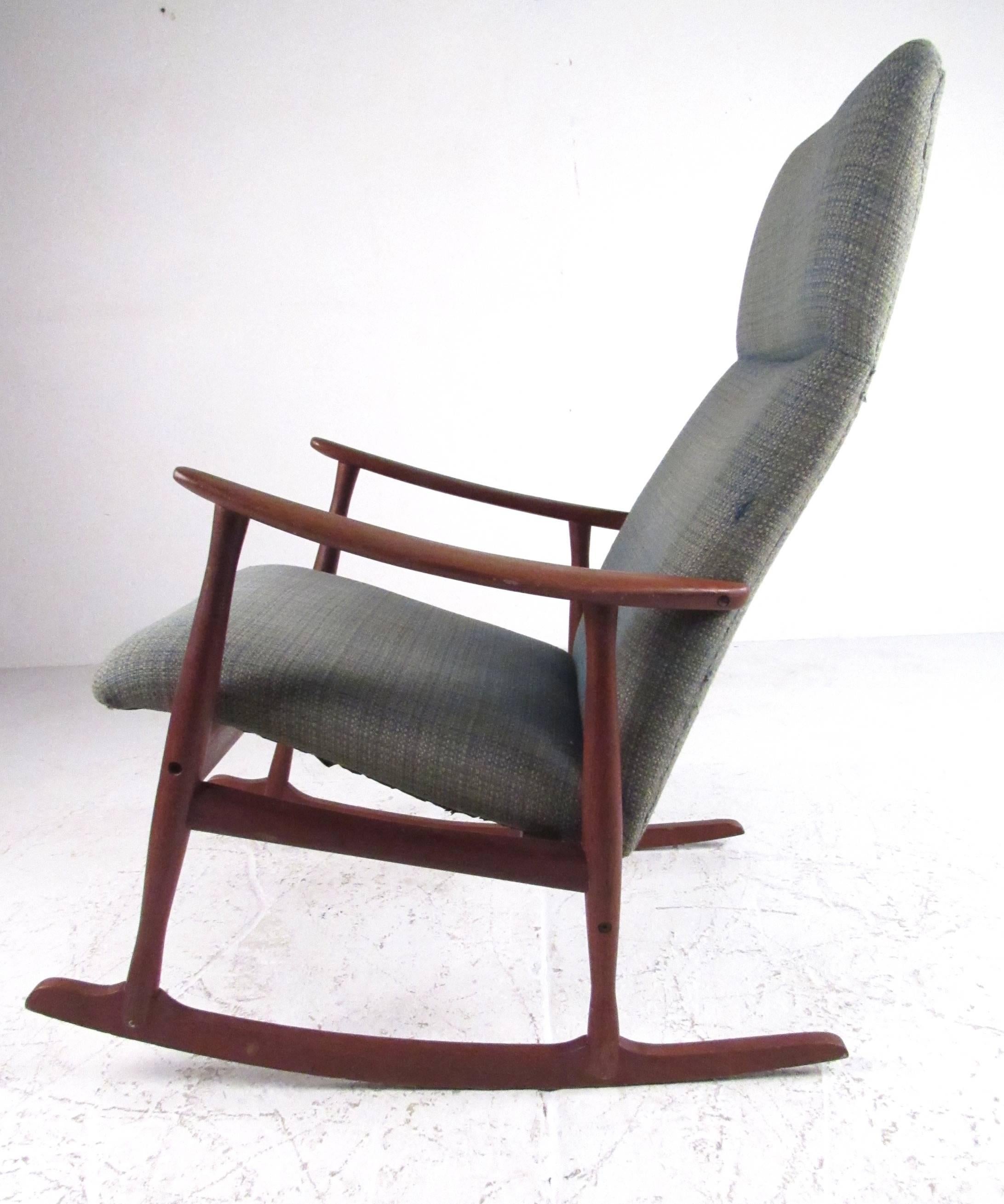 Vintage rocking chair with midcentury styling from Denmark, circa 1960. Very comfortable with solid teak construction, this Classic Danish design fits easily into any residential environment. Please confirm item location (NY or NJ) with dealer.