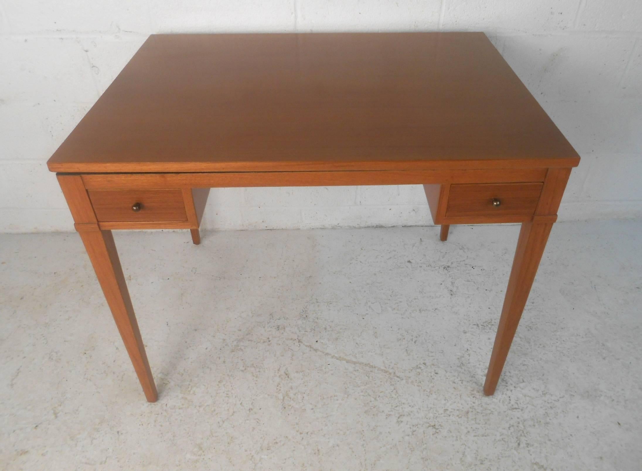 This versatile Mid-Century Modern desk has the ability to turn into a game table by flipping the top to the opposite side. Unique design has a chess board in the centre of the top on one side and a beautiful teak finish on the other side. Lovely