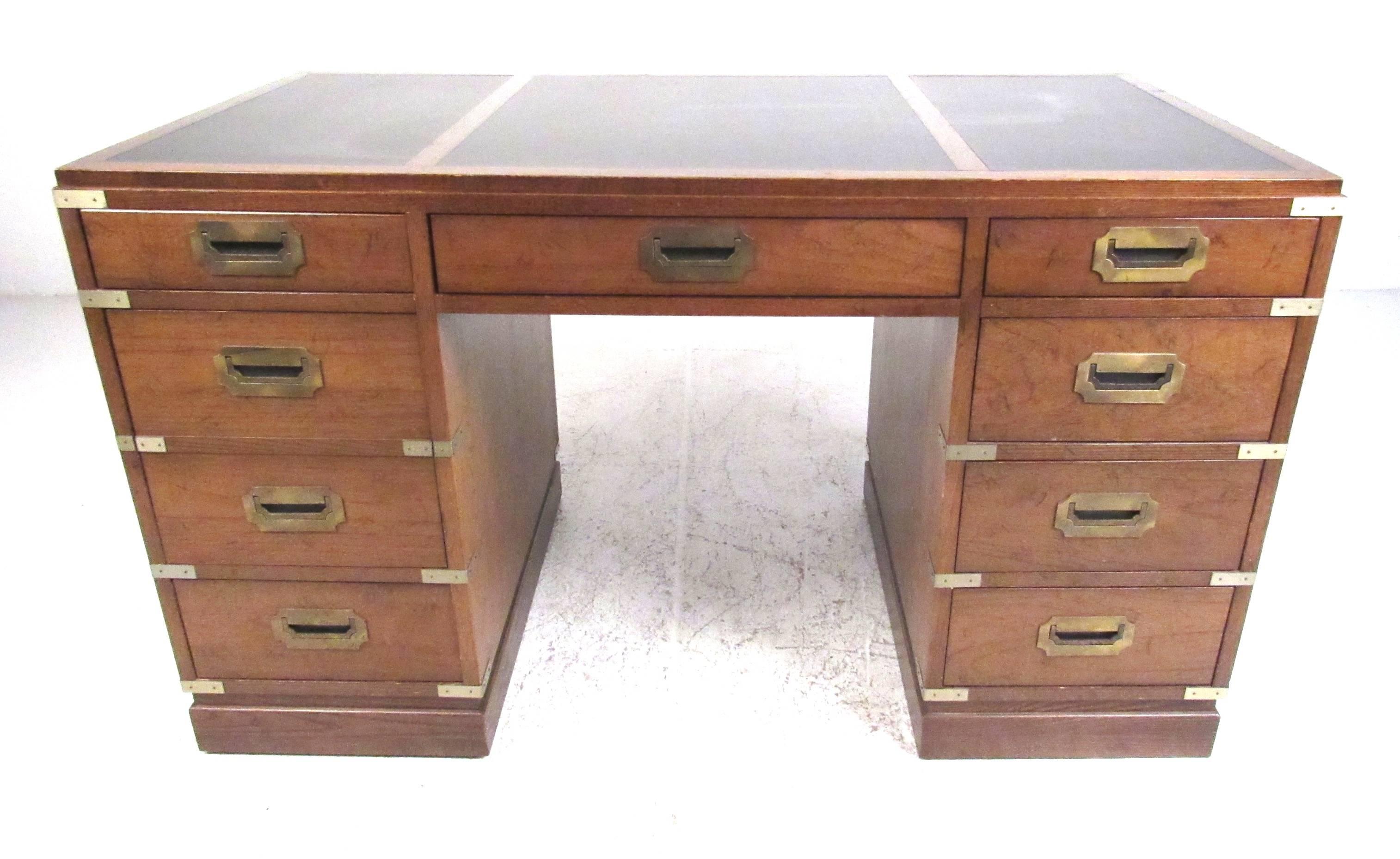 This campaign desk is a comfortable size to fit in various settings. Brass bound corners and pulls contrast nicely with the oak finish, and black top. Branded by Sligh of Holland/Grand Rapids, Michigan. Please confirm item location (NY or NJ). 