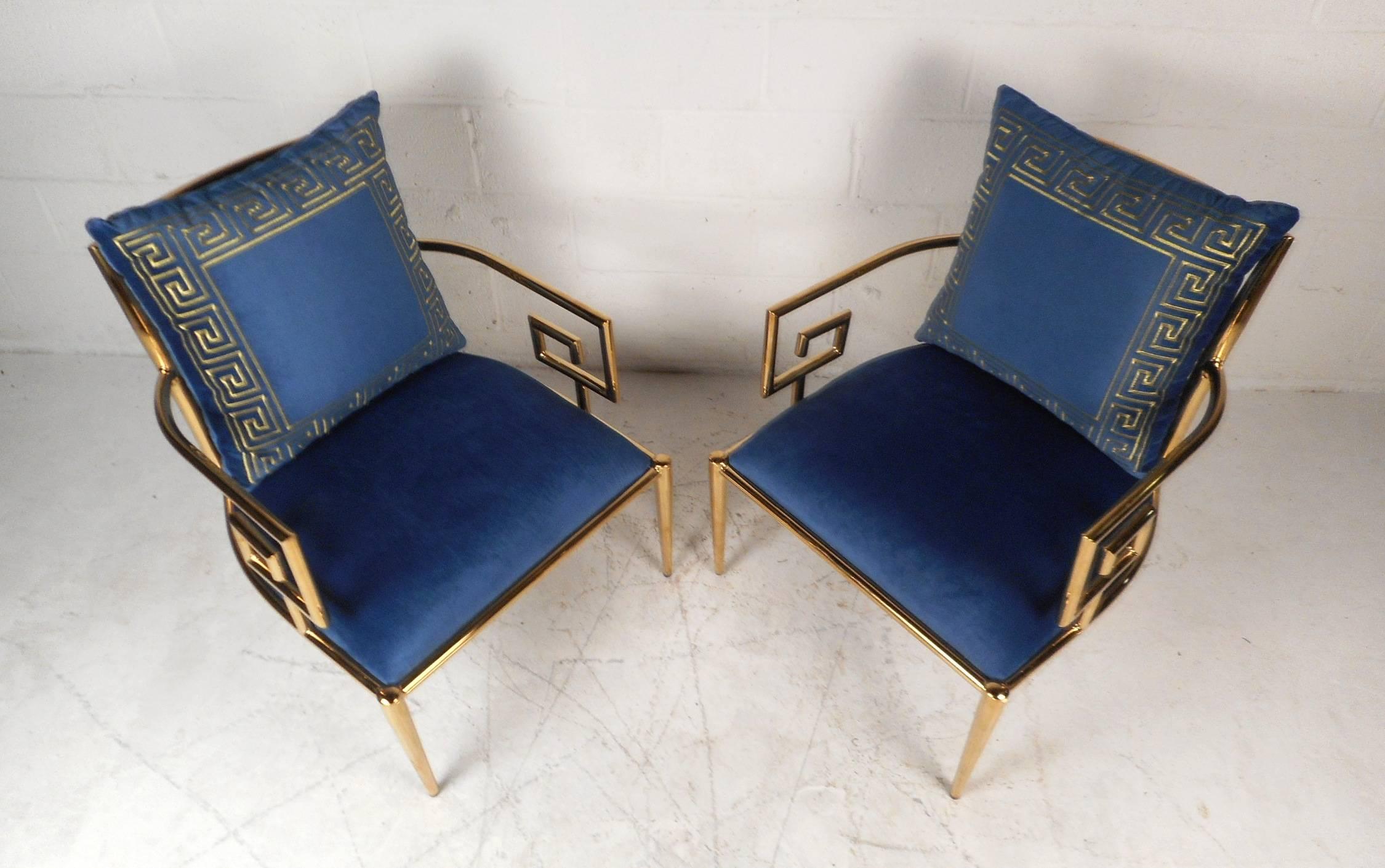 This gorgeous pair of vintage modern armchairs feature a tubular brass frame with unique arm rests. This gorgeous pair offers plenty of comfort with its thick padded seating and backrest. Lovely plush royal blue upholstery, tapered legs, and a