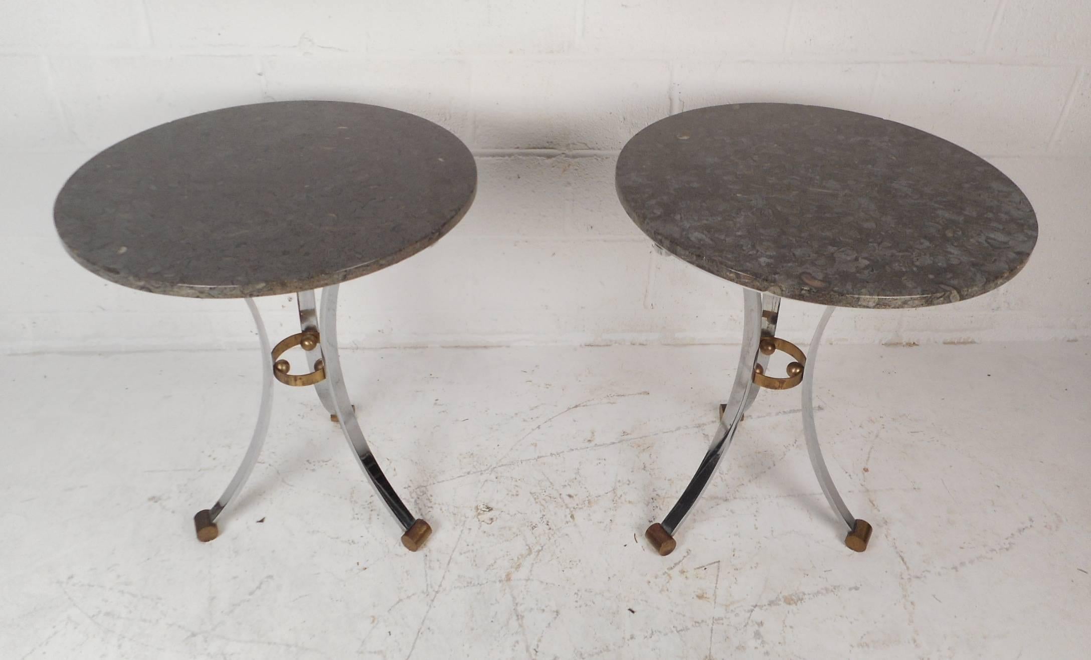 This stunning pair of vintage modern side tables feature a round marble top with unusual chrome bases. The smooth marble top with a wonderful design and brass feet adding to the allure. Heavy chrome base with a brass center support and splayed flat