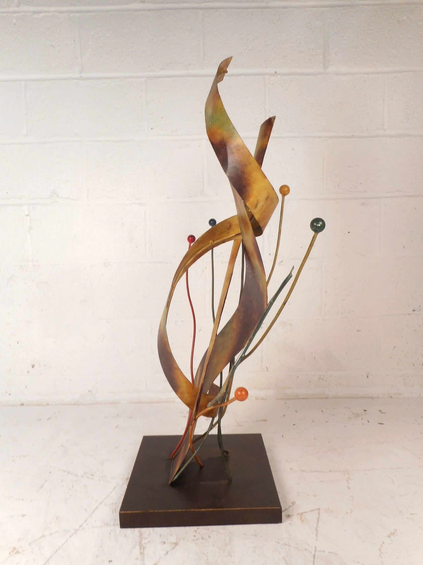 This beautiful vintage modern sculpture features a unique design with various elaborate colors and shapes. Creative piece sits on a square block and can be placed on any angle displaying a different design each side. Perfect eye catching addition to