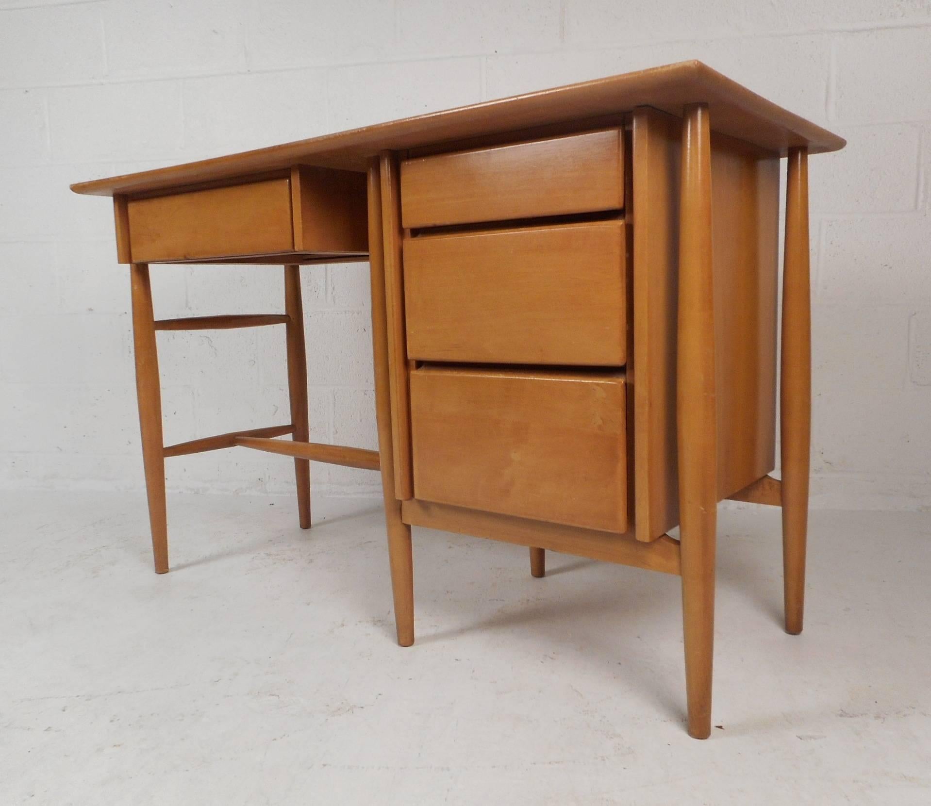 This beautiful vintage modern set includes a desk and a side chair. The desk is made of solid maple and features four large drawers. Quality craftsmanship with a finished back and a large top ensuring plenty of work space. The iconic side chair has