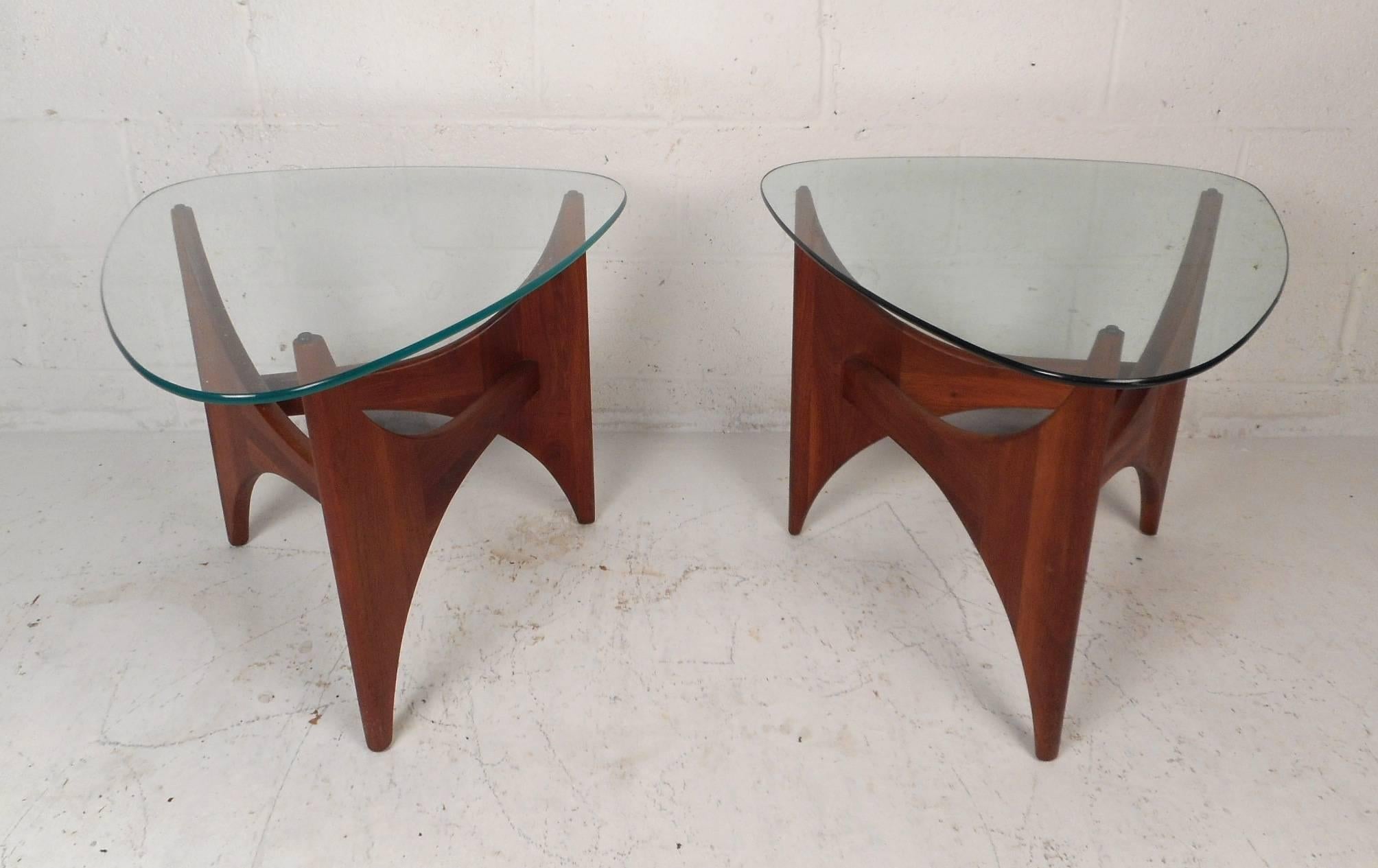 This gorgeous pair of vintage modern end tables feature triangular glass tops with a sculptural walnut base. These stylish and sturdy side tables make the perfect show stopping addition to any modern interior. Unique tapered design with sculpted
