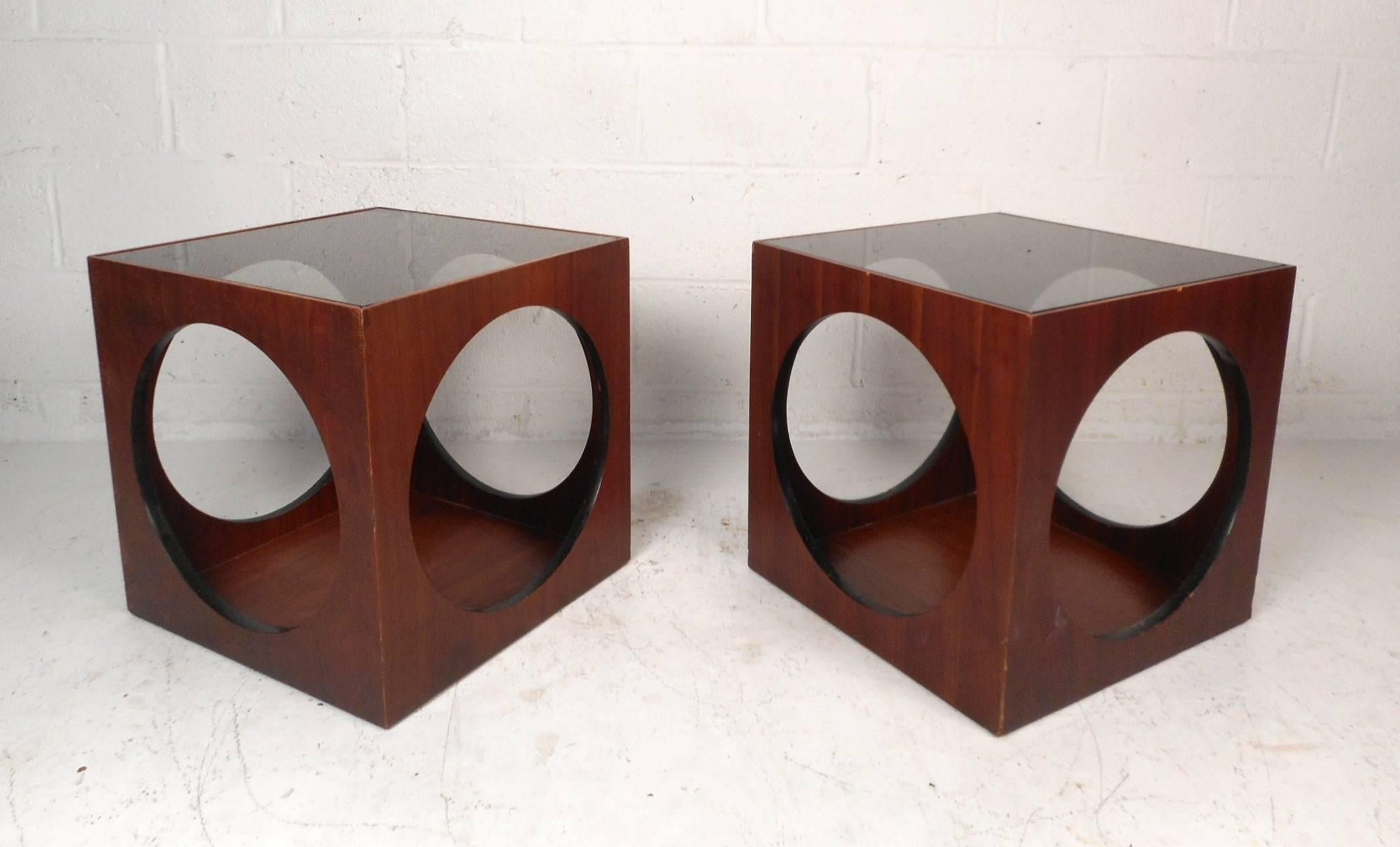 This beautiful pair of vintage modern end tables are designed in the style of Lane Furniture. Stylish design with unique cut-out sides and a smoked glass insert on the top. Wonderful dark walnut wood grain and the sleek cube shape make this