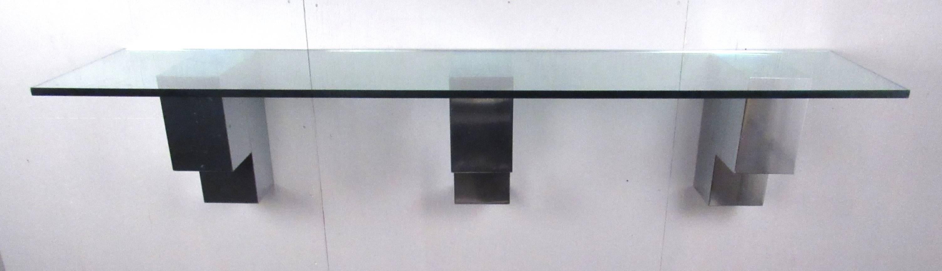 Modern style shelf featuring three chrome panelled wall mounted brackets supporting a 3/4
