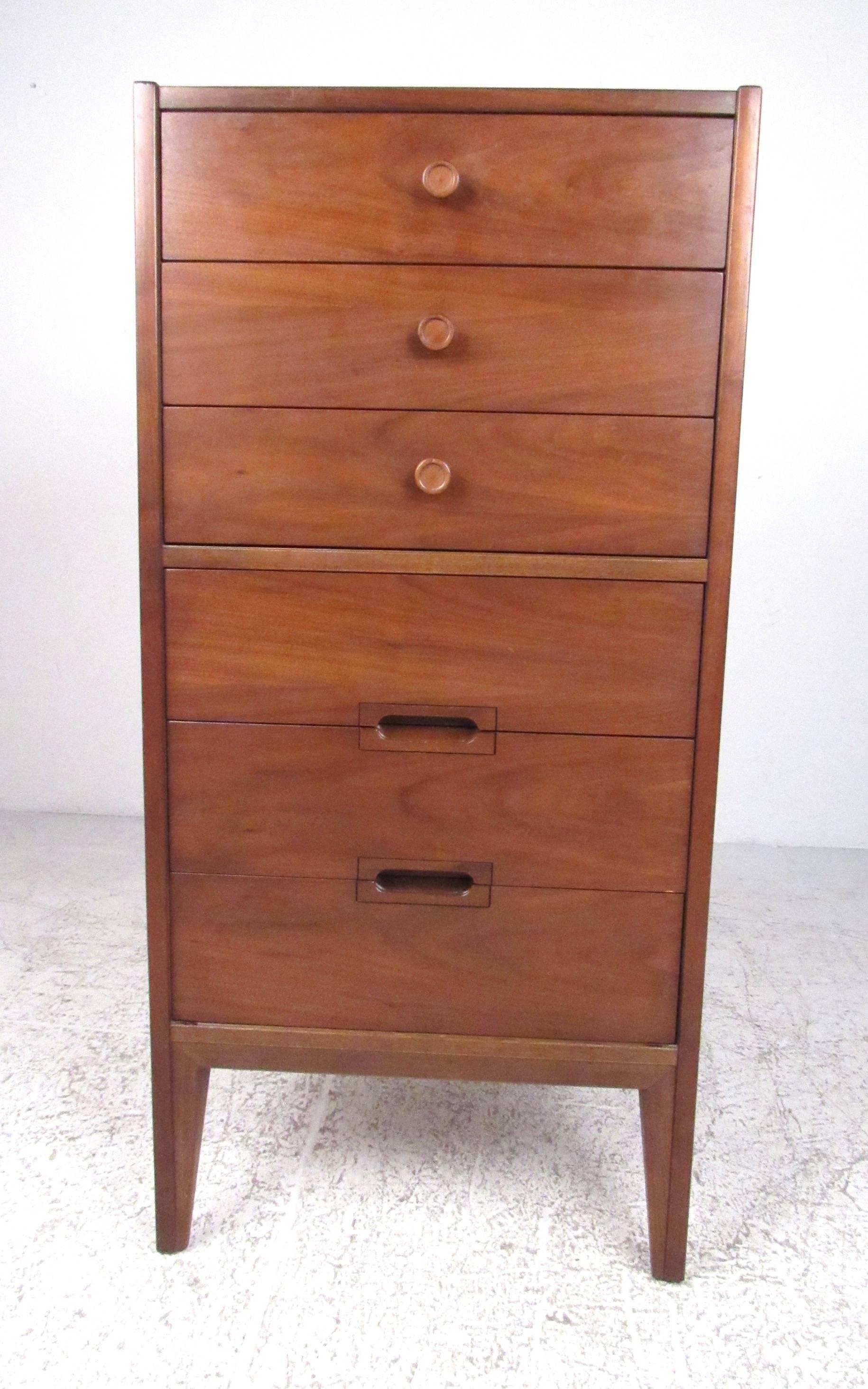 Narrow and tall, this six-drawer walnut dresser is both functional and an attractive Mid-Century Modern furnishing. Please confirm item location (NY or NJ) with dealer.