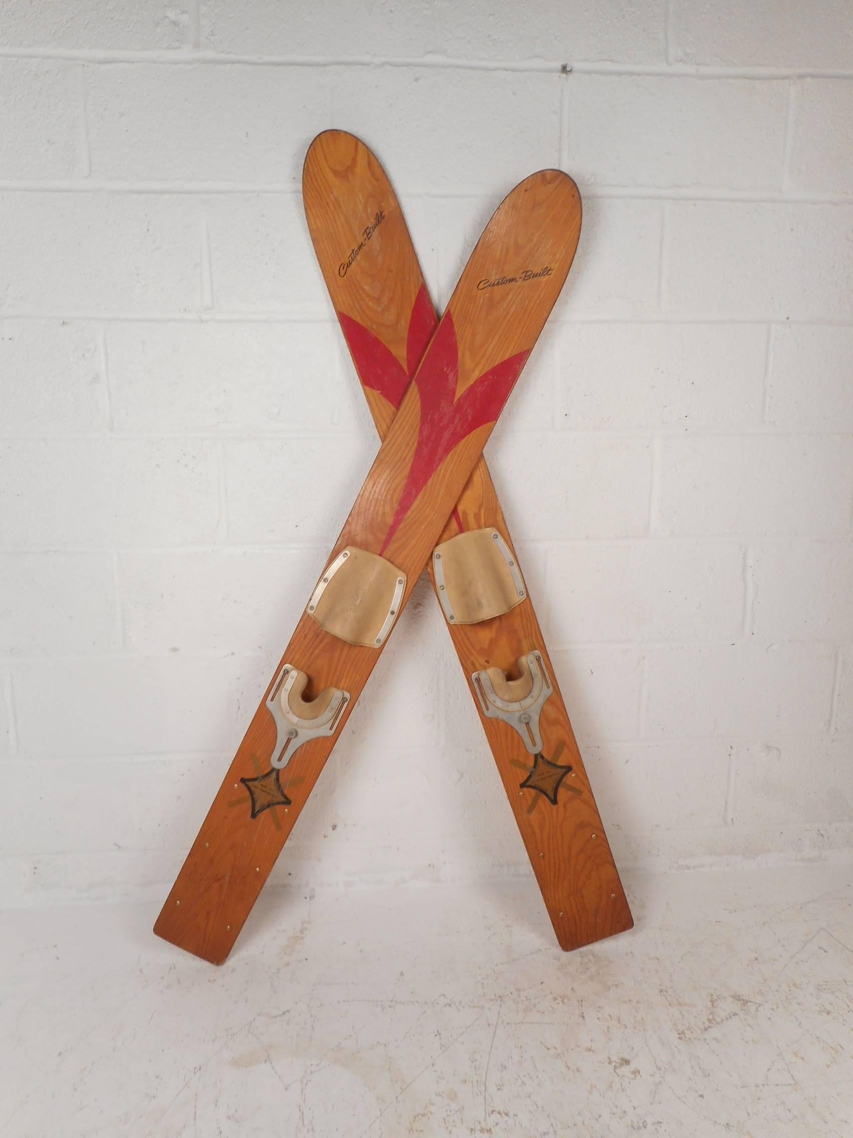 This excellent pair of vintage water skis are stamped, "White Ash Water Skis by Aqua Wood Products." This wonderful pair looks great as a decorative object on any wall. The custom build design and beautiful blonde sculpted wood adds to the