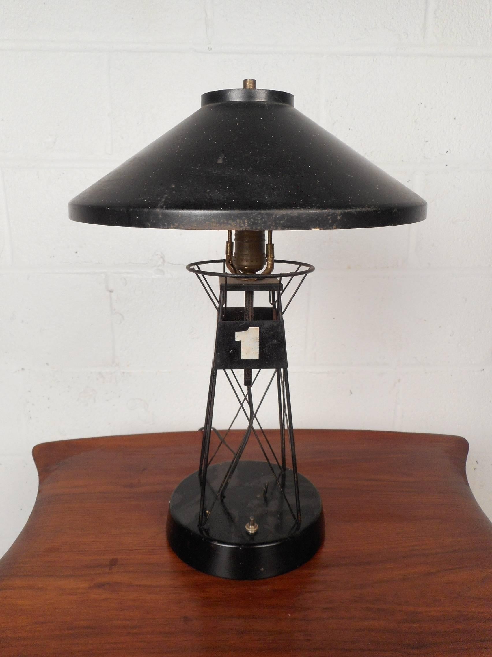 This gorgeous vintage table lamp is shaped like a lighthouse with the number one on it. The unique spoked design is made of metal. This wonderful lamp makes the perfect addition to any setting. Please confirm item location (NY or NJ).