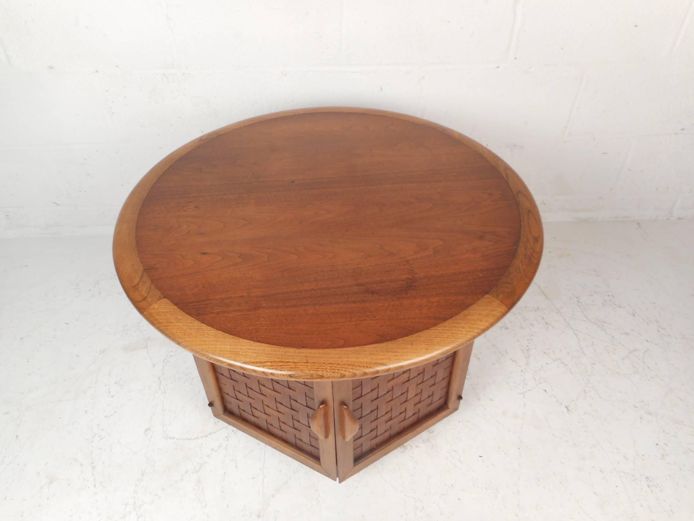 This beautiful vintage modern end table features two cabinet doors with woven fronts and sculpted pulls. Unique two-tone design with oak and walnut wood grain showing quality craftsmanship. This wonderful six-sided table with a large overhanging