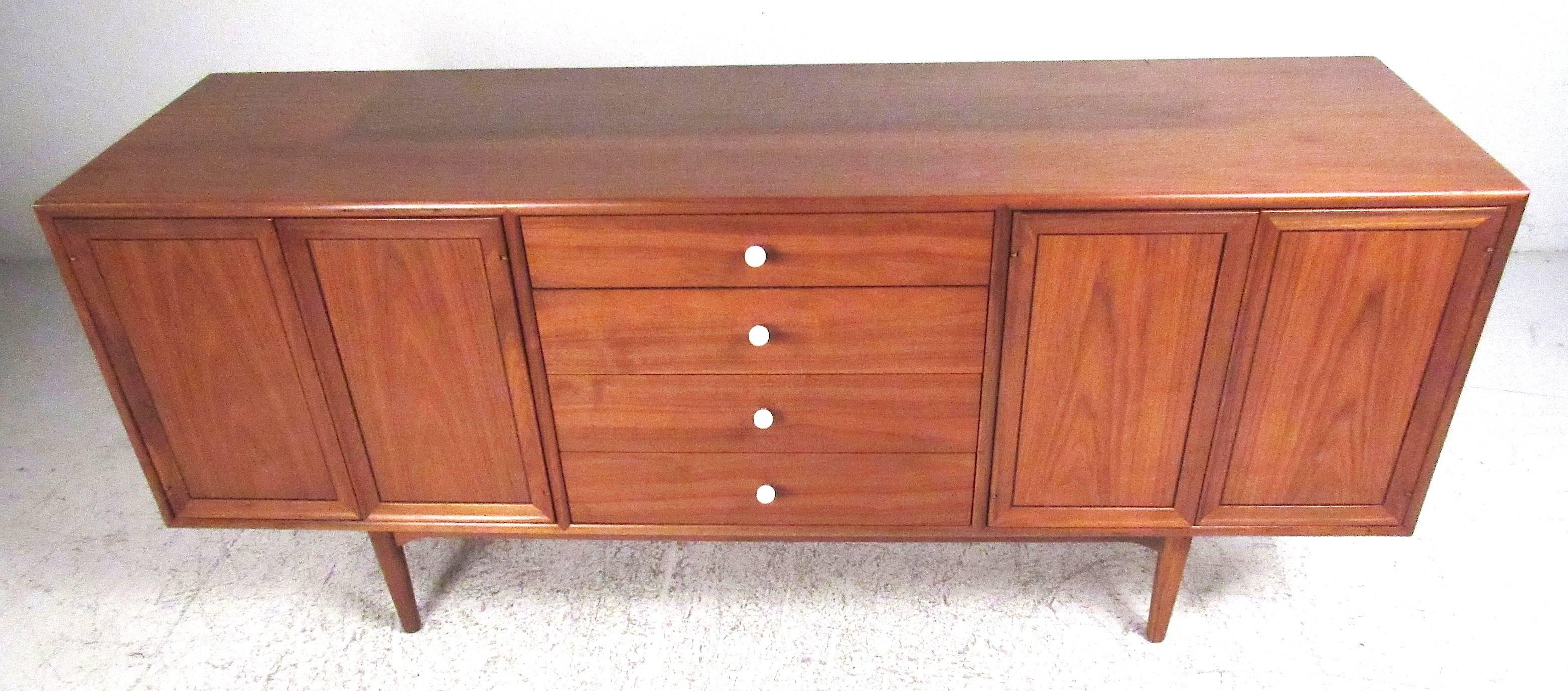 Midcentury Drexel Declaration credenza by Kipp Stewart and Stewart McDougall. Featuring four center drawers accented by white porcelain pulls, with double door storage compartments on both sides. Matching china cabinet which sits atop available (see