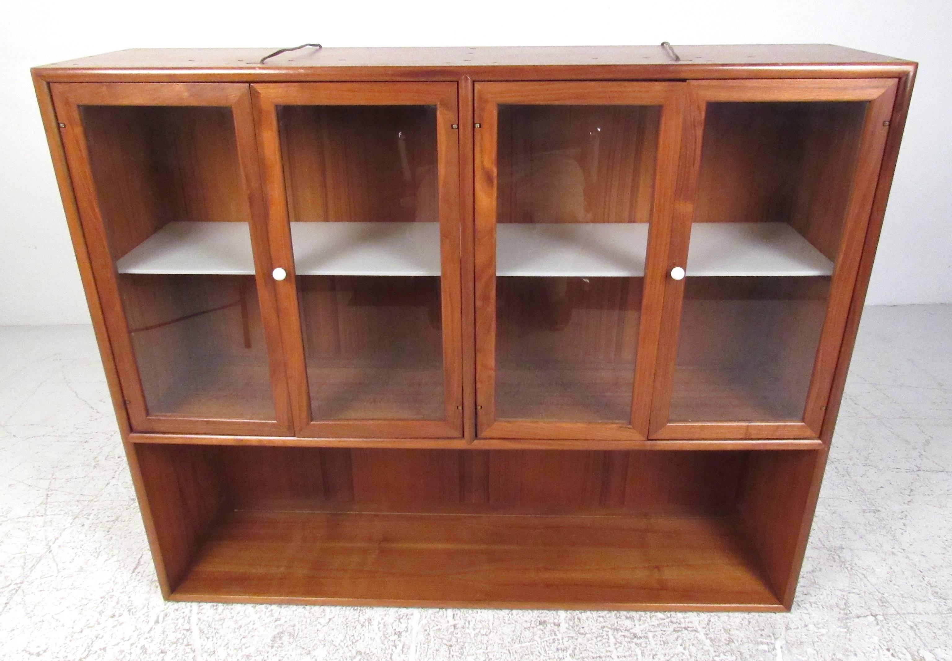 Four-door walnut China cabinet featuring internal lights, four adjustable shelves, porcelain pulls and plate groove for display. Matching server available (see photo). Please confirm item location (NY or NJ) with dealer.