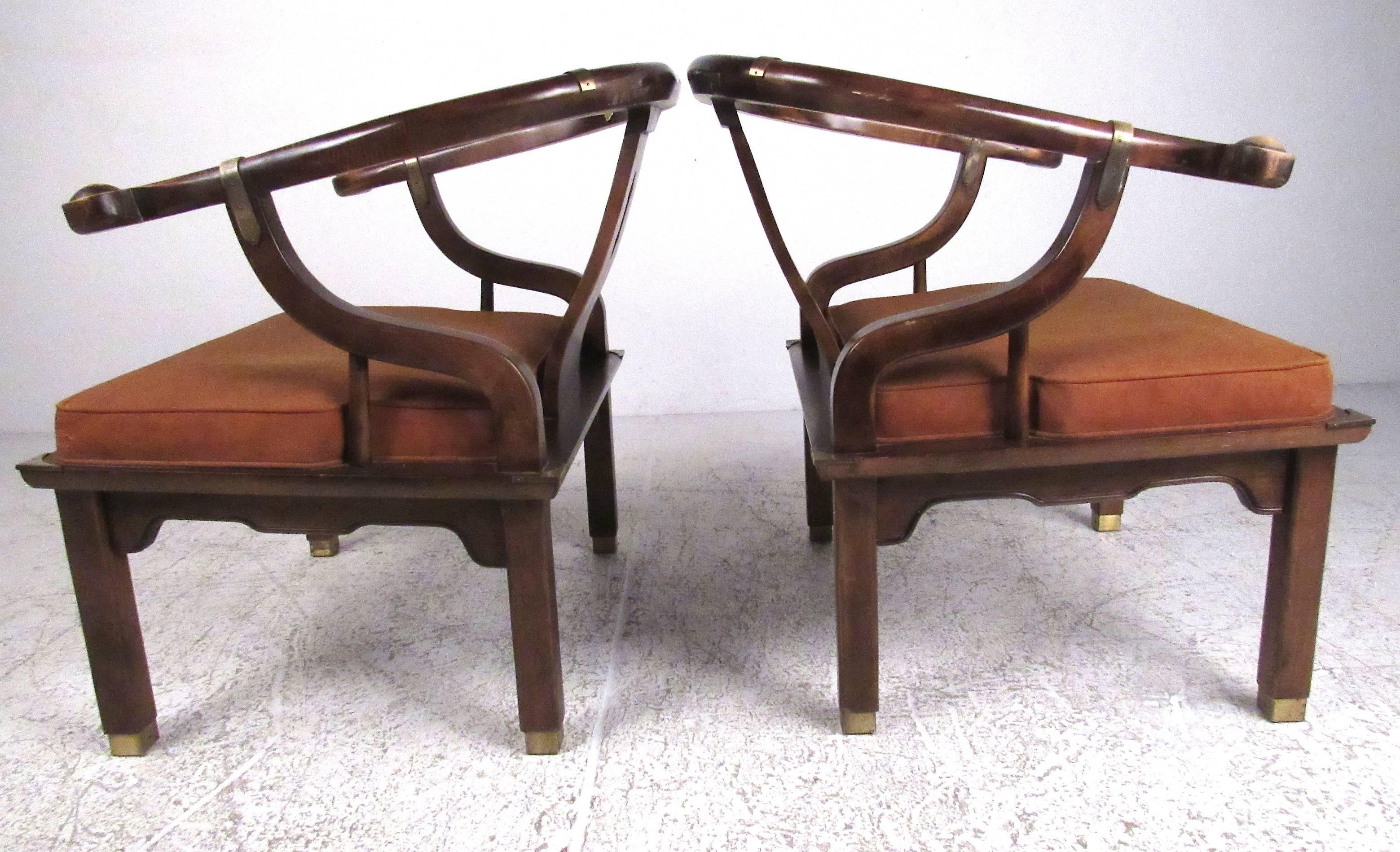 Horseshoe lounge chairs with attached cushion, brass sabots and brass banding in a warm natural wood finish. Please confirm item location (NY or NJ) with dealer.