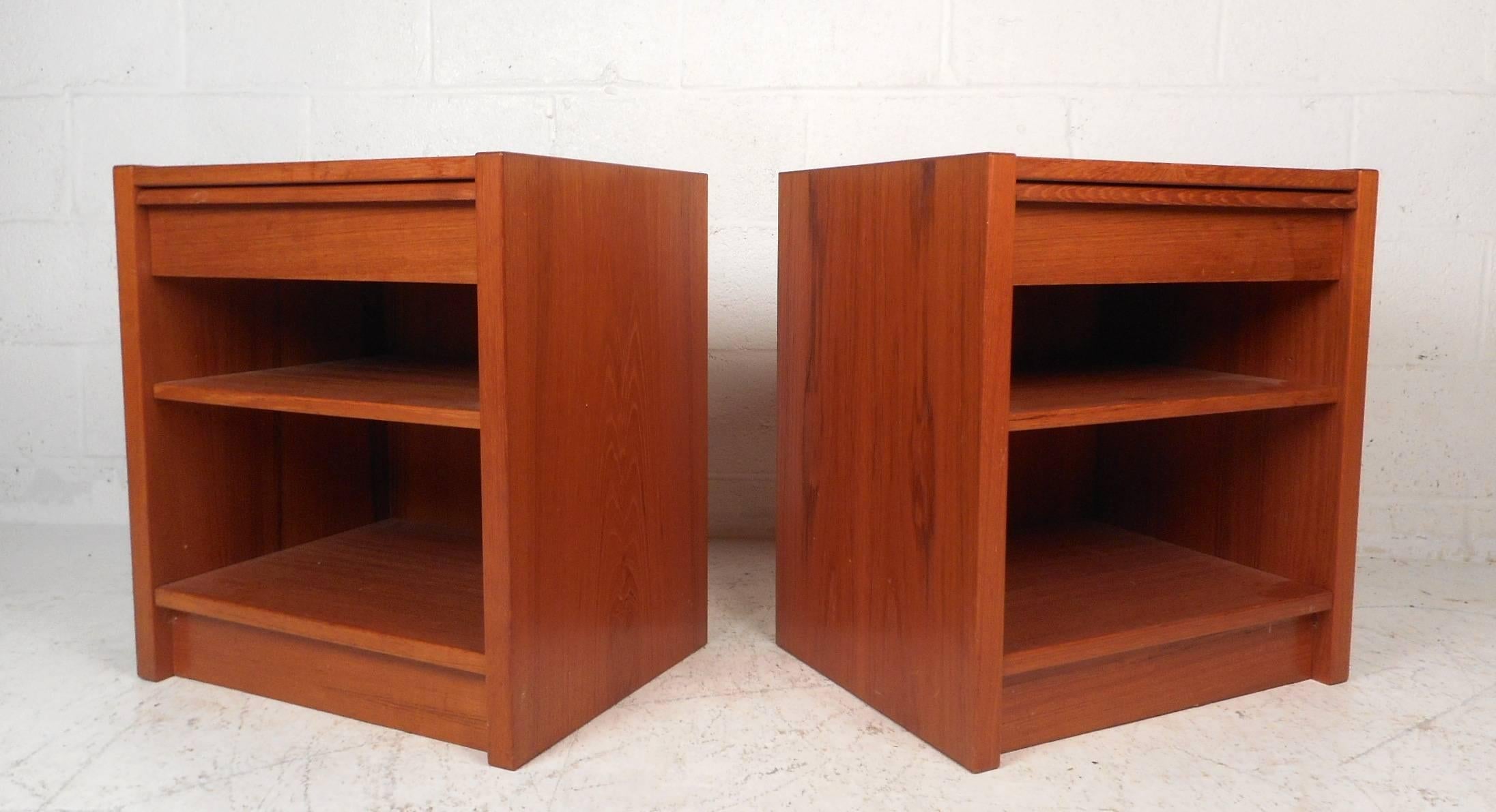 This gorgeous pair of vintage modern end tables feature one drawer and a large compartment with a shelf. Sleek design with plenty of room for storage and elegant teak wood grain throughout. Straight line construction and a unique hidden drawer pull