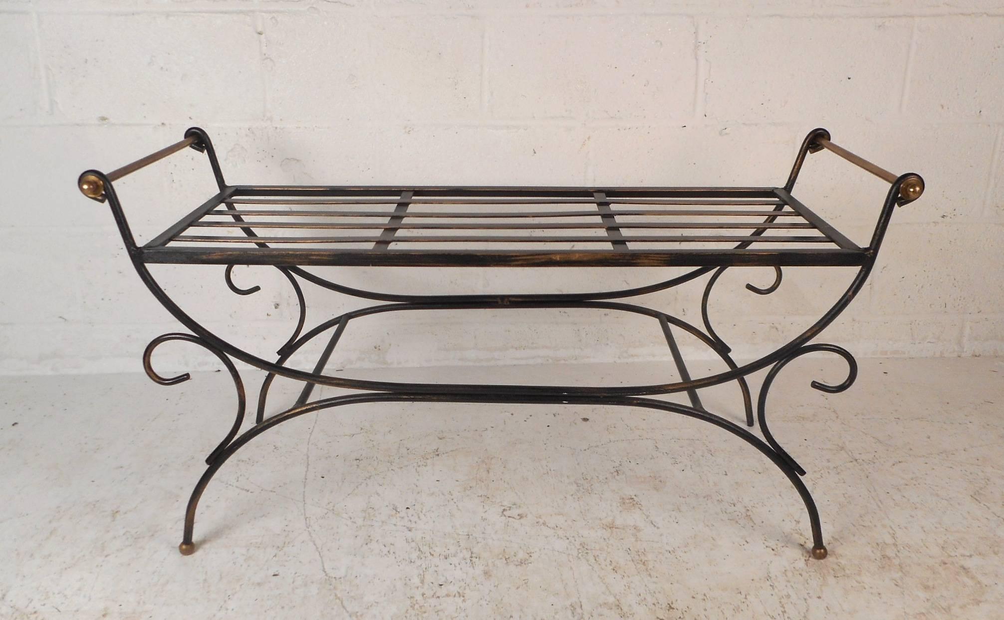 This gorgeous vintage wrought iron bench makes the perfect addition to any patio or outdoor setting. Unique design with scroll detail on the sides and curved legs. This wonderful piece has low arm rests on each side and a slatted seat. Please