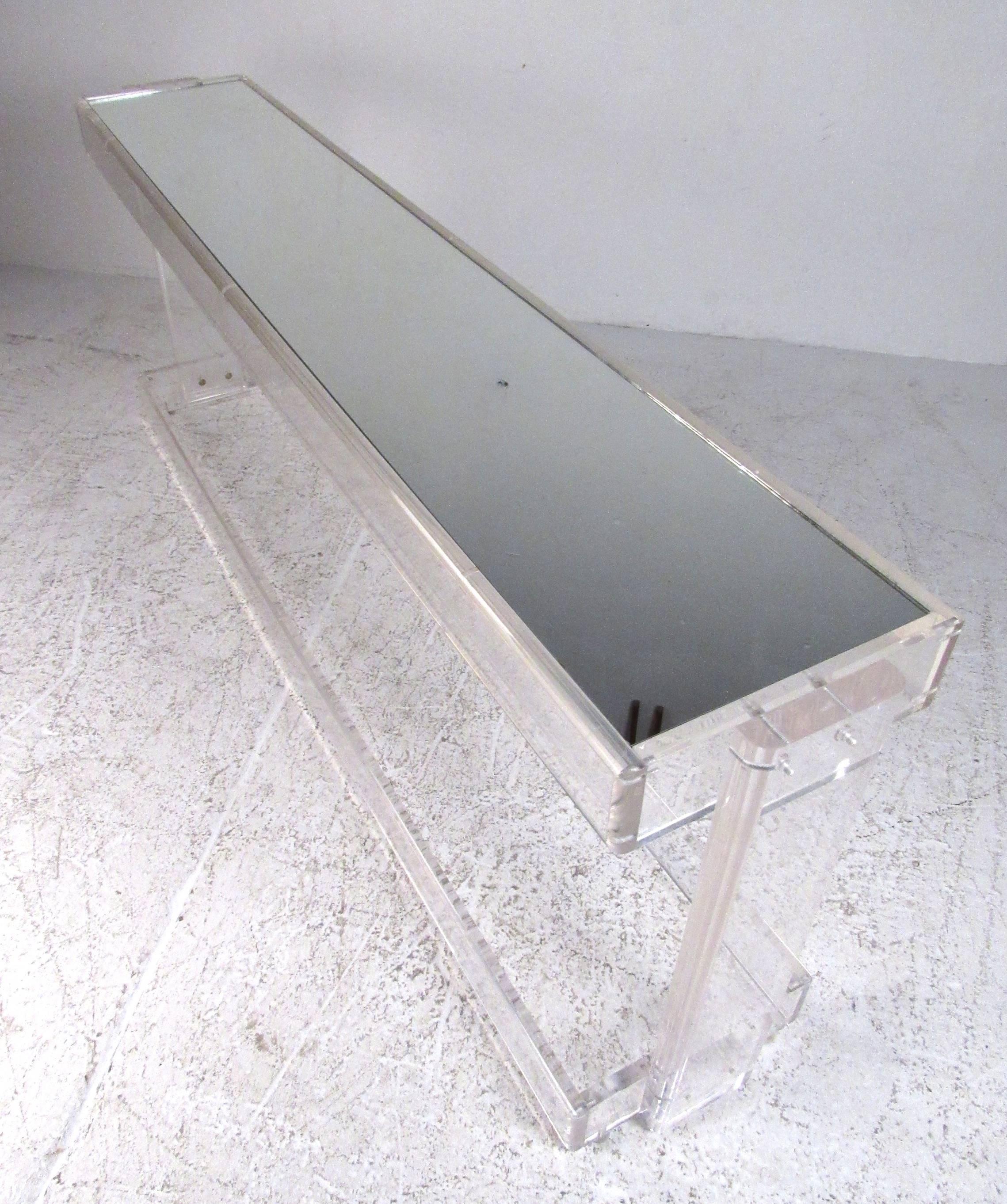 Long Mid-Century Modern two-tier console table with mirrored shelves. Great for an entry hall or a behind-the-sofa application. Please confirm item location (NY or NJ) with dealer.