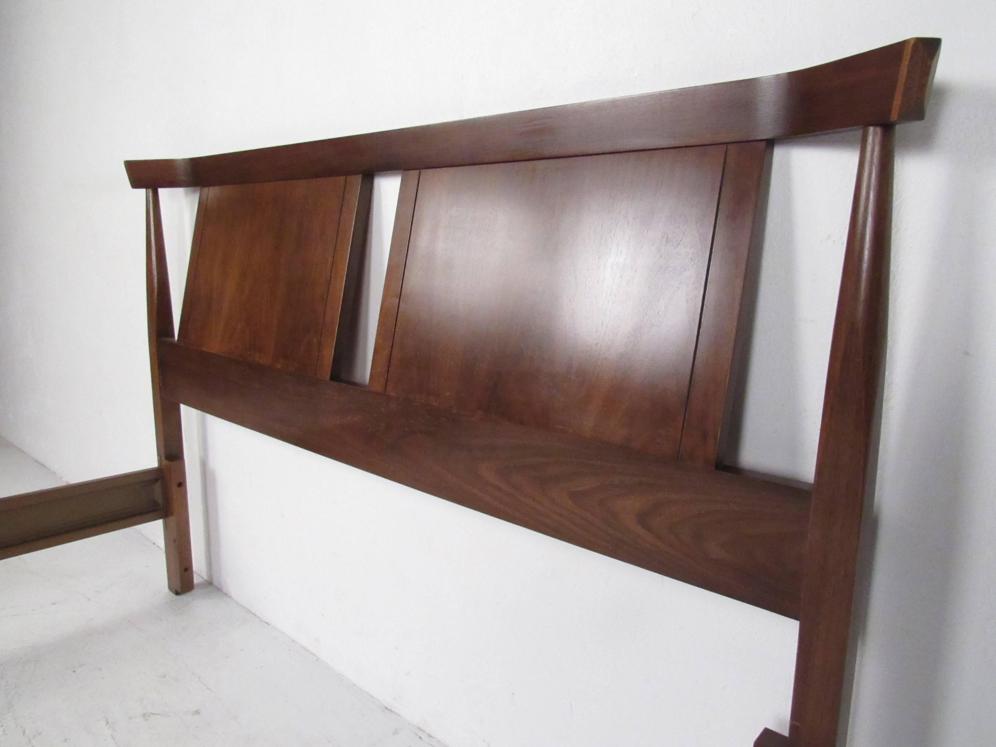 Full size bed frame with walnut headboard and footboard and metal side rails. (Footboard measures 57