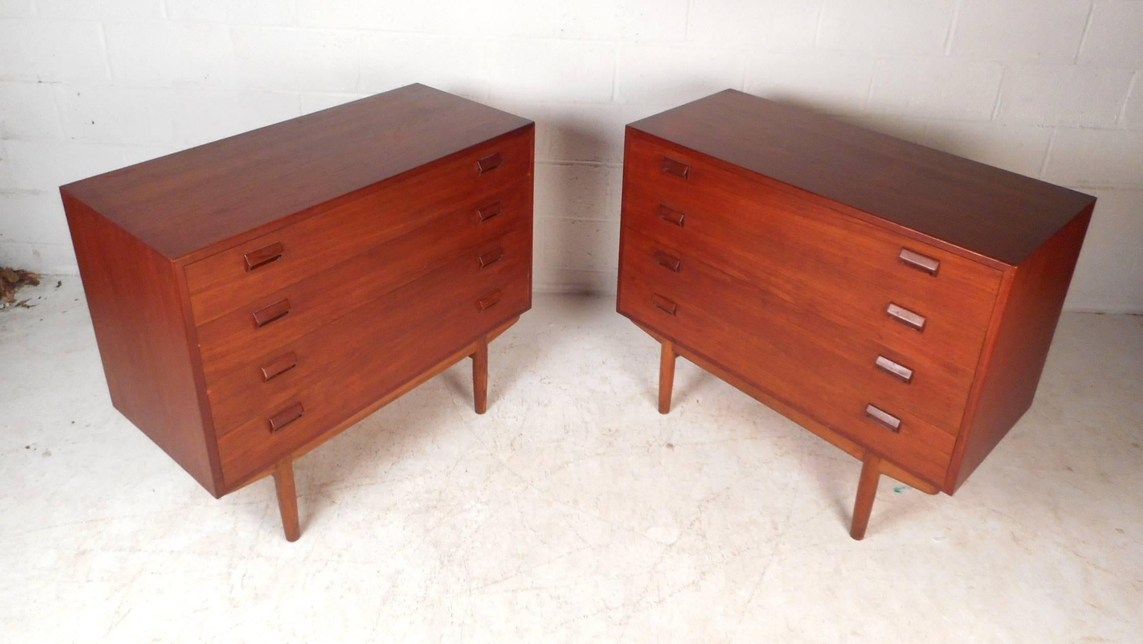 Stunning pair of vintage modern gentleman's chests with plenty of room for storage within their four hefty drawers. Sleek design with carved drawer pulls and sturdy tapered legs. These fabulous case pieces show quality with their dovetail