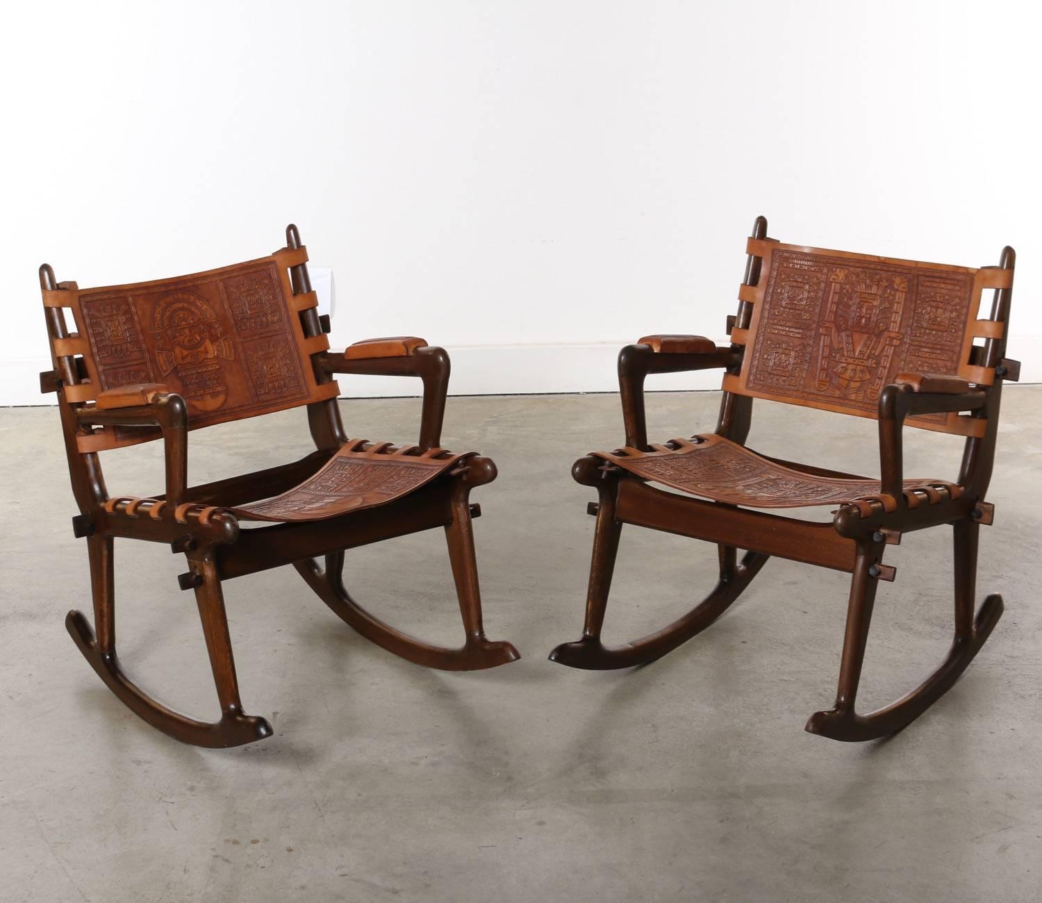 These fabulous wood and leather 1960s rocking chairs are held together by wooden dowels and are readily flat packed. The leather is in fabulous condition with tooled Aztec motif and great patina. The frames have the perfect amount of wear to give